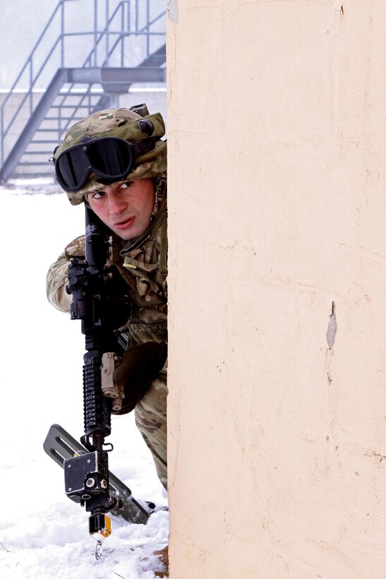 A Soldier assigned to Georgian Armed Forces, 33rd Battalion pulls security on the corner of a building during the close quarter combat portion of a cordon and search exercise, recently in Hohenfels, Germany. These soldiers are completing their mission readiness exercise as the final event of the latest rotation of the Georgia Deployment Program-International Security Assistance Force hosted and executed by Marine Forces, Europe, Marine Corps Security Cooperation Group and U.S. Army soldiers stationed at the Joint-Multinational Readiness Center in Hohenfels, Germany. The GDP-I was started in 2009 to provide security cooperation training to the GAF in preparation for their deployments to Afghanistan where they are responsible for their own area of responsibility and work closely with U.S. Marines in the region. 