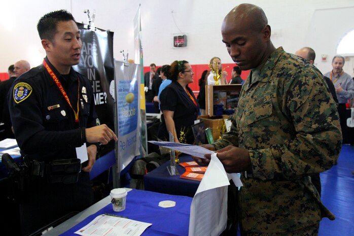 Sgt. Christopher A.Thompson, senior drill instructor, Company C, 1st Recruit Training Battalion, gathers information about different opportunities the Career and Education Fair hosted by Marine Corps Community Services' Personal and Professional Development aboard Marine Corps Recruit Depot San Diego Feb. 13. MCCS hosted the semi-annual event for service members and their families to establish contacts, gather information and submit applications for employment and continuing education.