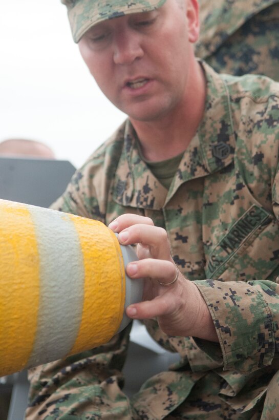 Staff Sgt. Sean Obrien,a Marine Aviation Logistics Squadron 13 Operations Chief based at Marine Corps Air Station Yuma, Ariz. and native of Glen Ellyn, Ill. teaches Marines how to quickly put together a Mark 82 explosive. Elements of Marine Attack Squadron 311 and Marine Aircraft Group 13 HQ also participated in the educational bomb-making training exercise.