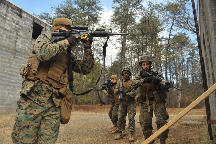 Marines from 4th Combat Engineer Battalion, prepare to enter a building through a window during pre-mobilization and annual training at Quantico’s Combat Town on Feb. 20. Military Operations on Urban Terrain training helps units learn firsthand about different tactics and techniques in urban terrain within the operating forces.