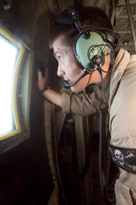130209-M-BY384-066 5th FLEET AREA OF RESPONSIBILITY (Feb. 9, 2013) Lance Cpl. Joshua Weisneth, VMGR-352, 15thMarine Expeditionary Unit, looks out the window of a CK-130 Hercules to ensure the AV-8B Harrier that conducted an aerial refueling mission has disconnected from the refueler with no problems, Feb. 9.  The 15th MEU is deployed as part of the Peleliu Amphibious Ready Group as a U.S. Central Command theater reserve force, providing support for maritime security operations and theater security cooperation efforts in the U.S. 5th Fleet area of responsibility. 