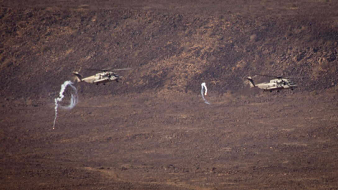 U.S. Marine Corps CH-53E Super Stallions from Marine Medium Helicopter (HMM-364 REIN) fire off flares and conduct live fire gun runs on designated range targets on Djibouti training impact area AR-11, Djibouti, February 11, 2013.  The 15th MEU is conducting sustainment training on various ranges throughout the host nation in preparation for any real world crisis.  (U.S. Marine Corps photo by: Master Sgt John A. Lee, II. /Released)