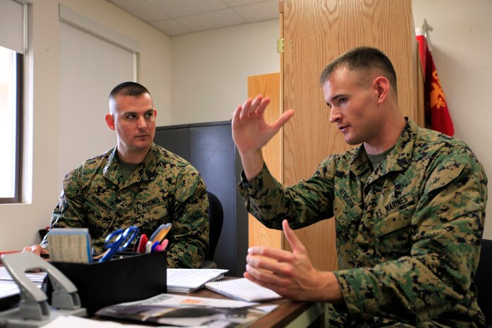 Sgt. Michael T. Henson, an electronics maintenance technician with the 11th Marine Regiment, explains his career situation to Gunnery Sgt. Jeremy L. Hammock, a Manpower Management Support Branch–50 career counselor, before receiving professional advice from Hammock. Marines attending Sergeant’s Course received one-on-one occupational guidance to improve their chances for promotion during a visit from MMSB–50 here Feb. 19-21. 