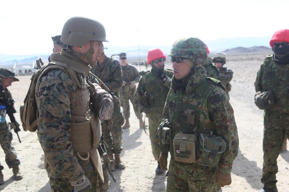 MARINE CORPS AIR GROUND COMBAT CENTER, TWENTYNINE PALMS, Calif. - Marine reservist Lance Cpl. Sungwoo Hur, translator and riflemen with 2nd Battalion, 23rd Marine Regiment, 4th Marine Division, translates for the Japan Ground Self Defense Force as part of Exercise Iron Fist 2013 at Marine Corps Air Ground Combat Center, Twentynine Palms, Calif., Jan. 28 2013. During Exercise Iron Fist 2013, the 13th Marine Expeditionary Unit and Japan Ground Self Defense Force spent three weeks participating in bilateral training which improved their interoperability, enhanced military-to-military relations, and sharpened skills essential to crisis response. (U.S. Marine Corps photo by Lance Cpl. Demetrius Morgan/ Released)      