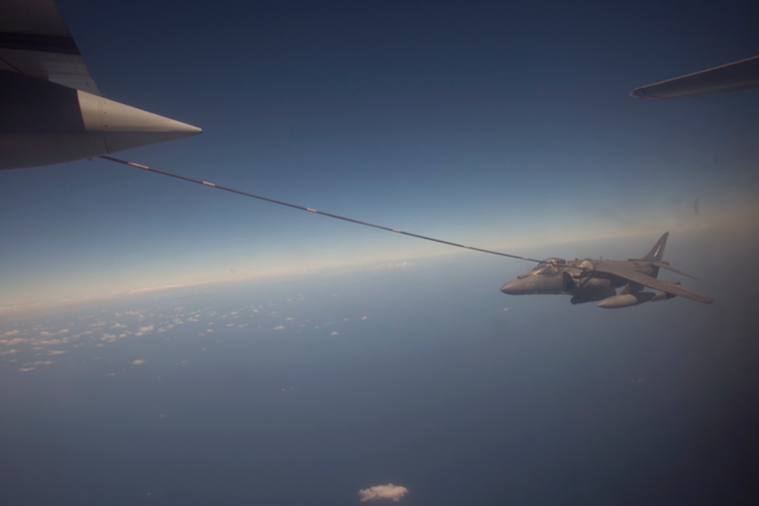 130209-M-BY384-054 5th FLEET AREA OF RESPONSIBILITY (Feb. 9, 2013)  An AV-8B Harrier with Marine Medium Helicopter Squadron 364 (Rein.), connects to the fuel line of a KC-130 Hercules refueling aircraft during an aerial refueling mission, Feb. 9.  The 15th MEU is deployed as part of the Peleliu Amphibious Ready Group as a U.S. Central Command theater reserve force, providing support for maritime security operations and theater security cooperation efforts in the U.S. 5th Fleet area of responsibility. 