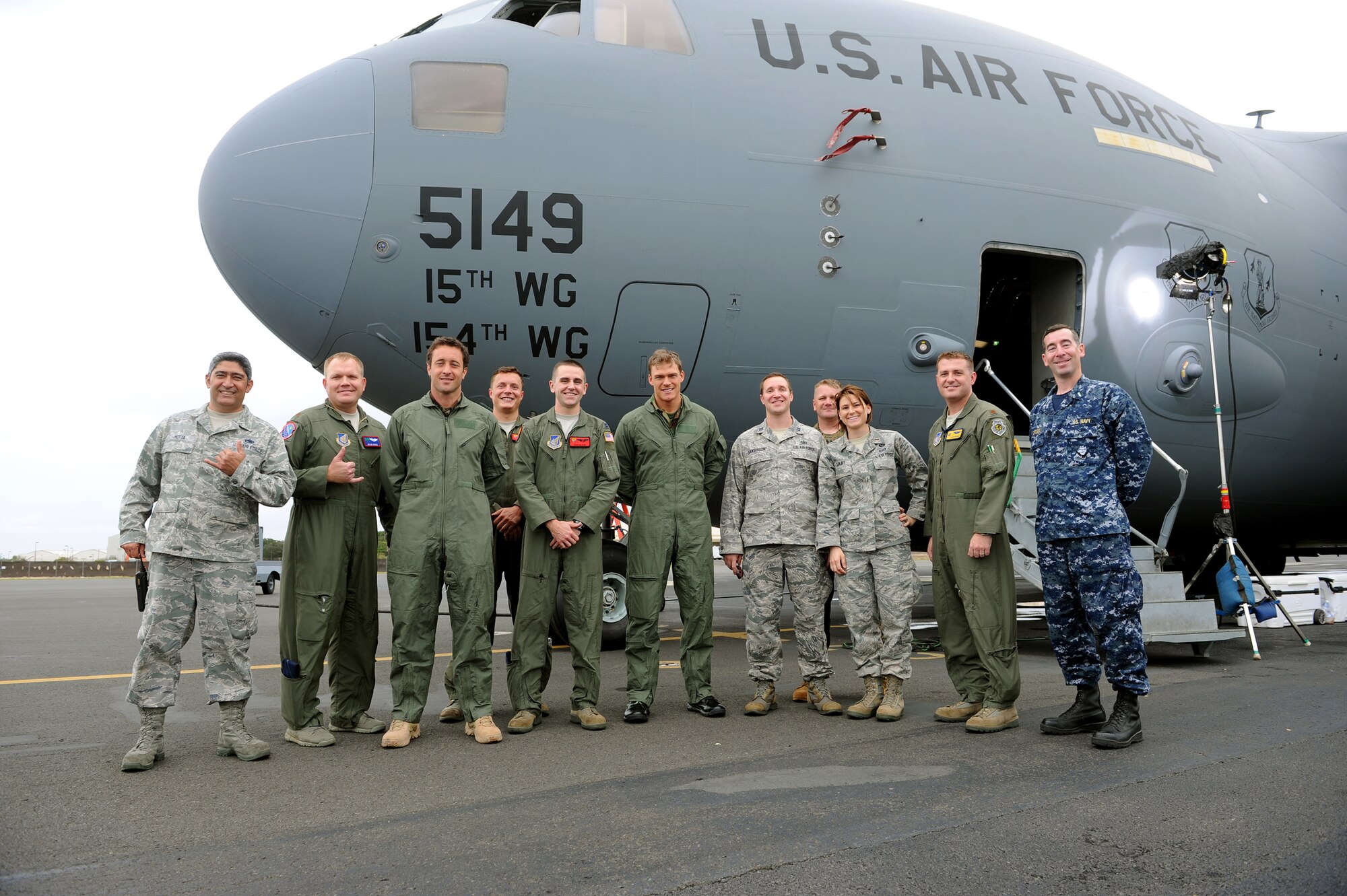 Servicemembers pose with actors from "Hawaii Five-0" standing in front of a C-17 Globemaster prior to filming a portion of an upcoming episode at Joint Base Pearl Harbor-Hickam, Hawaii, Feb. 21, 2013. (U.S. Air Force photo/Tech. Sgt. Jerome S. Tayborn)