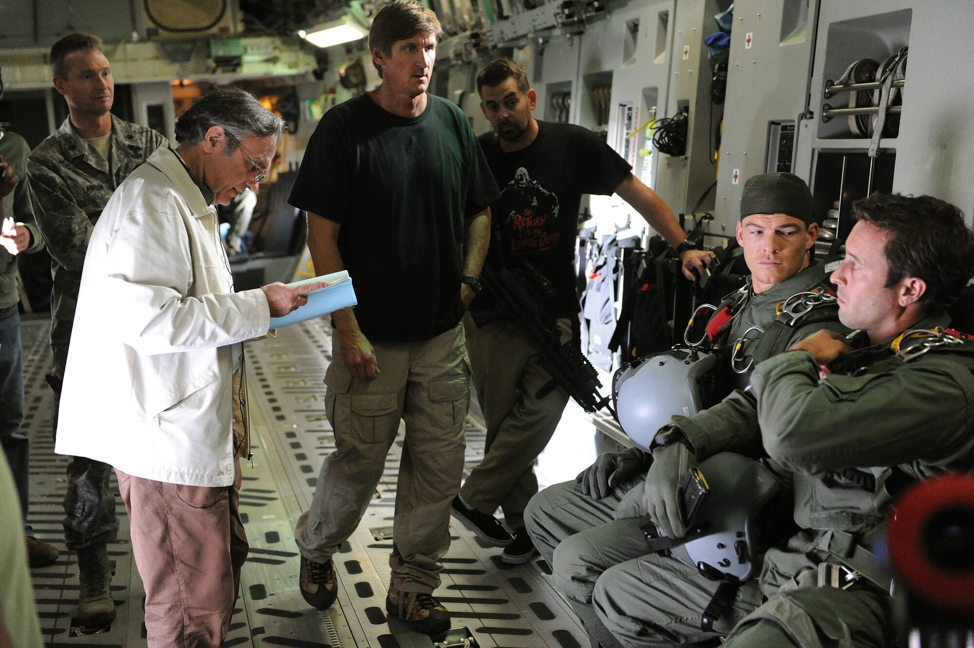 Production crew members and actors Alan Ritchson (right) and Alex O’Loughlin (far right) and from the goes over the script during a scene from “Hawaii Five-0” being filmed aboard a C-17 Globemaster at Joint Base Pearl Harbor-Hickam, Feb. 21, 2013.  The crew and cast were on scene to shoot a portion of an upcoming episode. (U.S. Air Force photo/Tech. Sgt. Jerome S. Tayborn)