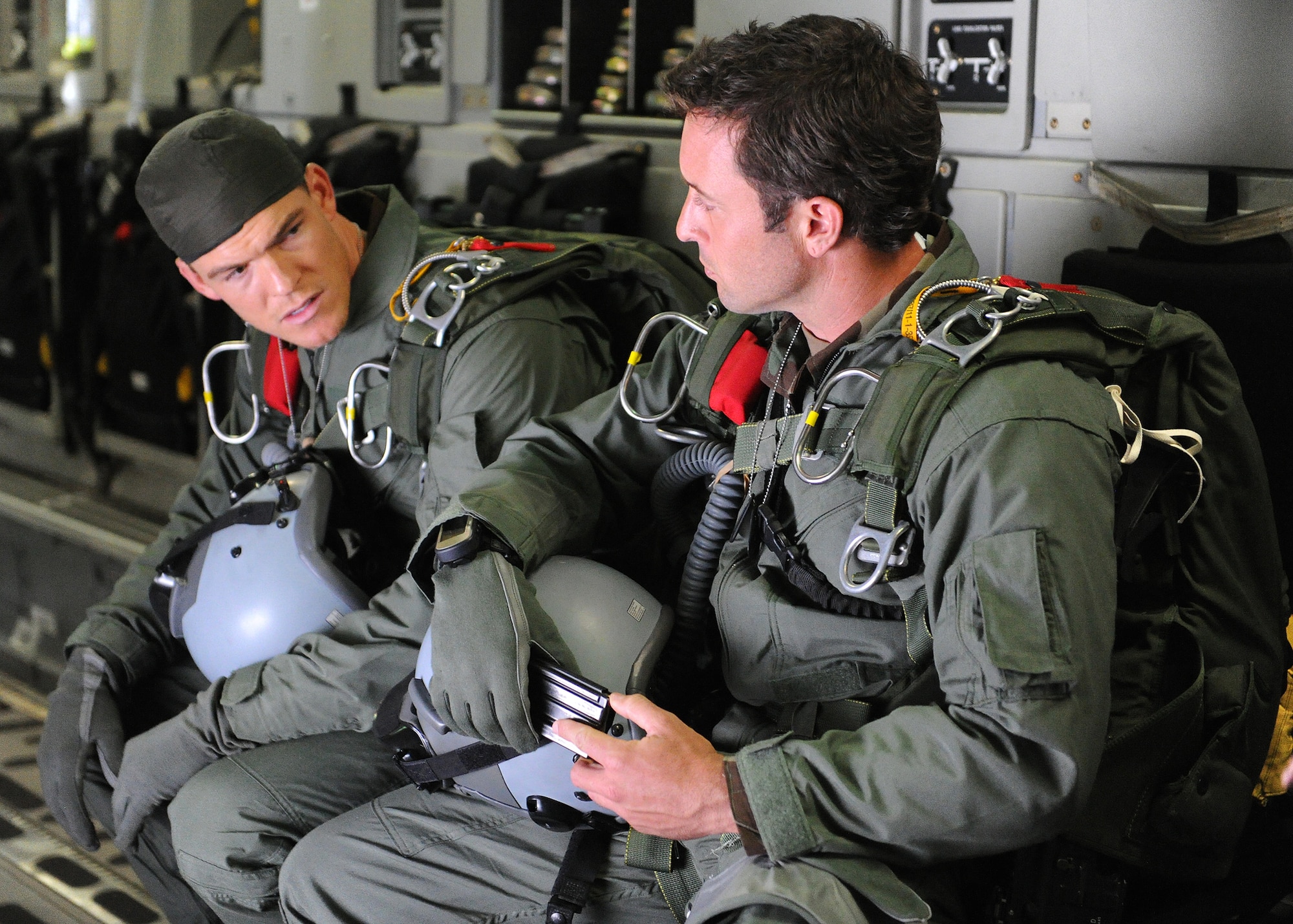 “Hawaii Five-0” actors Alan Ritchson and Alex O’Loughlin (right) go over their lines during a filming scene aboard a C-17 Globemaster at Joint Base Pearl Harbor-Hickam, Feb. 21, 2013.  The crew and cast were on scene to shoot a portion of an upcoming episode. (U.S. Air Force photo/Tech. Sgt. Jerome S. Tayborn) 
