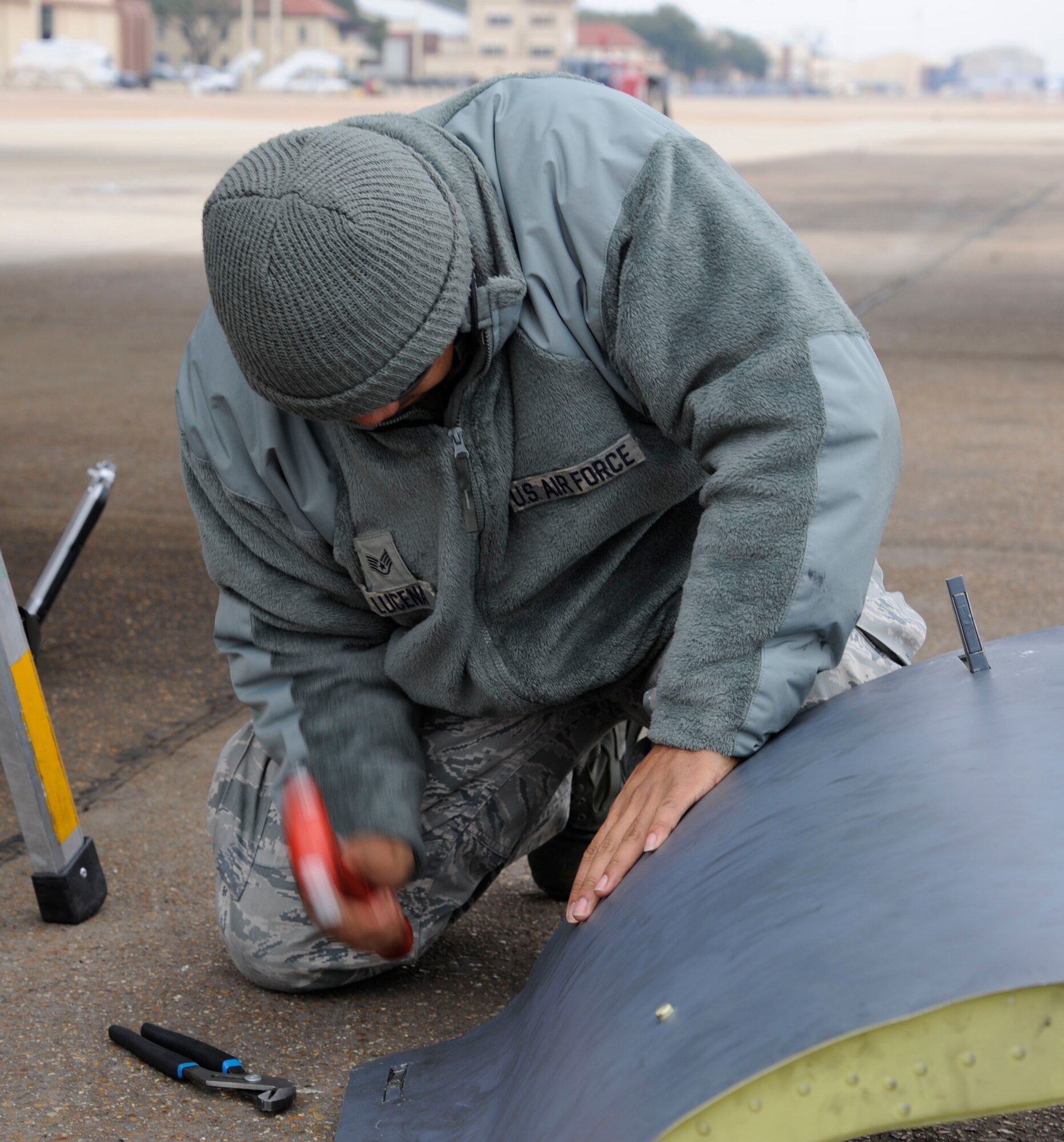 Staff Sgt. Ian Lucena, 20th Aircraft Maintenance Squadron, attempts to extract a broken B-52H Stratofortress engine cowling latch on Barksdale Air Force Base, La., Feb. 22. The cowlings provide protection to the B-52s engine fans and systems, so maintenance Airmen must perform constant checks to ensure all components are working correctly. (U.S. Air Force photo/Airman 1st Class Andrew Moua)