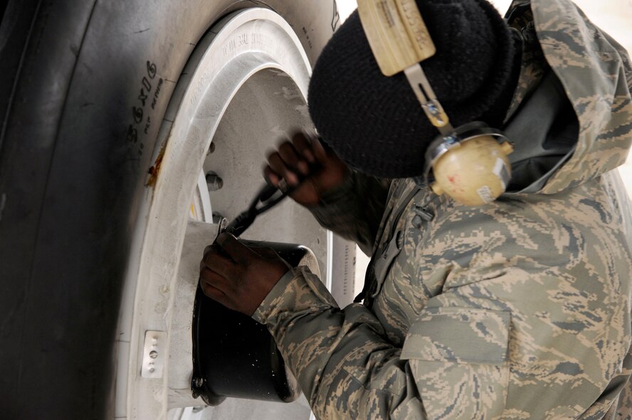 Airman 1st Class Jamichael Wiley, 20th Aircraft Maintenance Squadron, installs safety wiring to an anti-skid cap on the wheel of a B-52H Stratofortress on Barksdale Air Force Base, La., Feb. 22. The wiring and caps prevent the wheels from skidding along the ground during landings. (U.S. Air Force photo/Airman 1st Class Andrew Moua)