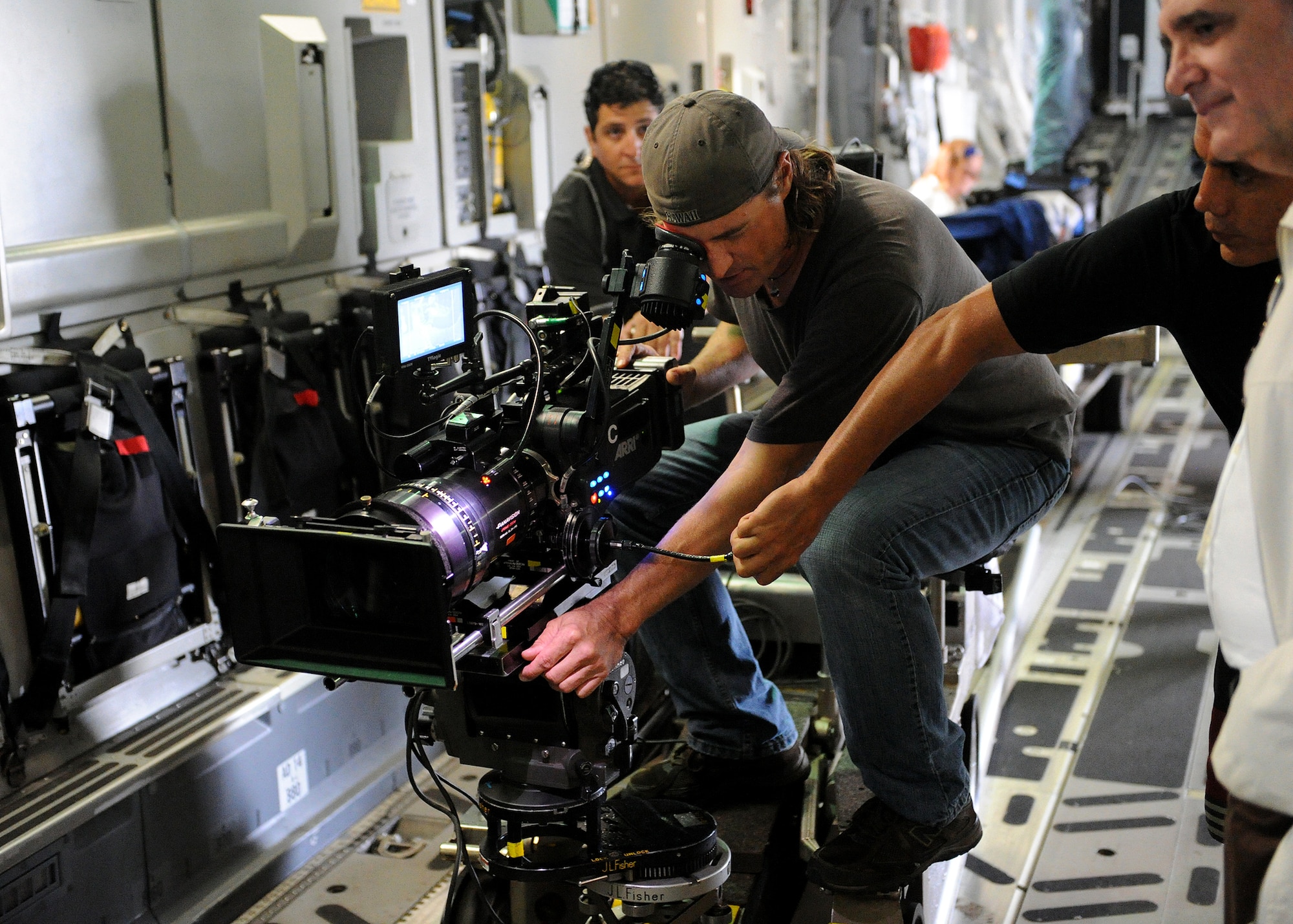 A camera crew from “Hawaii Five-0” prepares to film a scene aboard a C-17 Globemaster at Joint Base Pearl Harbor-Hickam, Feb. 21, 2013.  The crew and cast were on scene to shoot a portion of an upcoming episode. (U.S. Air Force photo/Tech. Sgt. Jerome S. Tayborn)