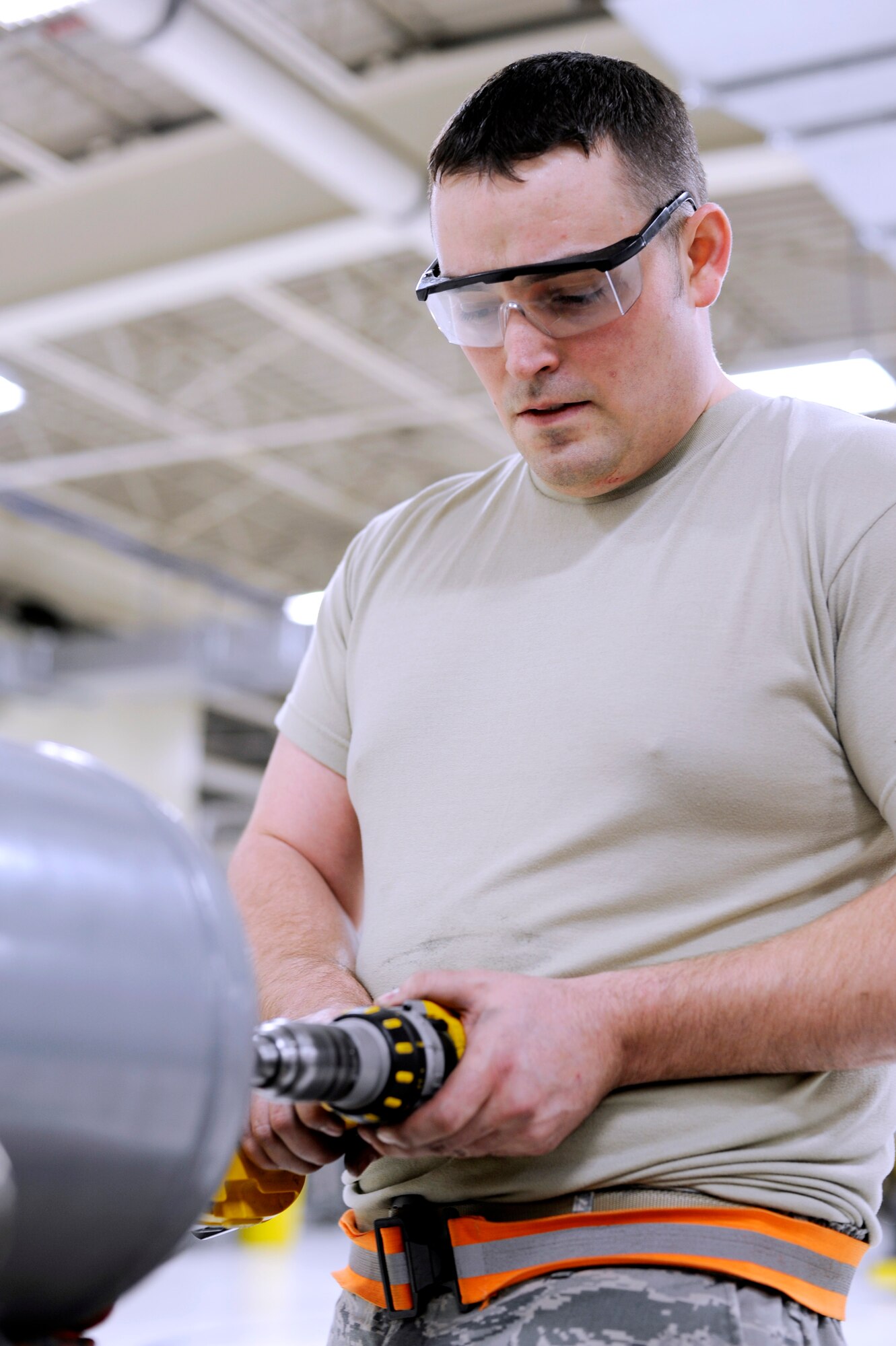 U.S. Air Force Staff Sgt. Justin Hammel, 354th Maintenance Squadron aerospace ground equipment mechanic, drills an air cylinder from an MC2A air compressor Feb. 5, 2013, Eielson Air Force Base, Alaska. The MC2A portable compressor is used for certain low-pressure application on the flightline, such as providing air to vehicles and aircraft tires. (U.S. Air Force photo/Staff Sgt. Jim Araos)