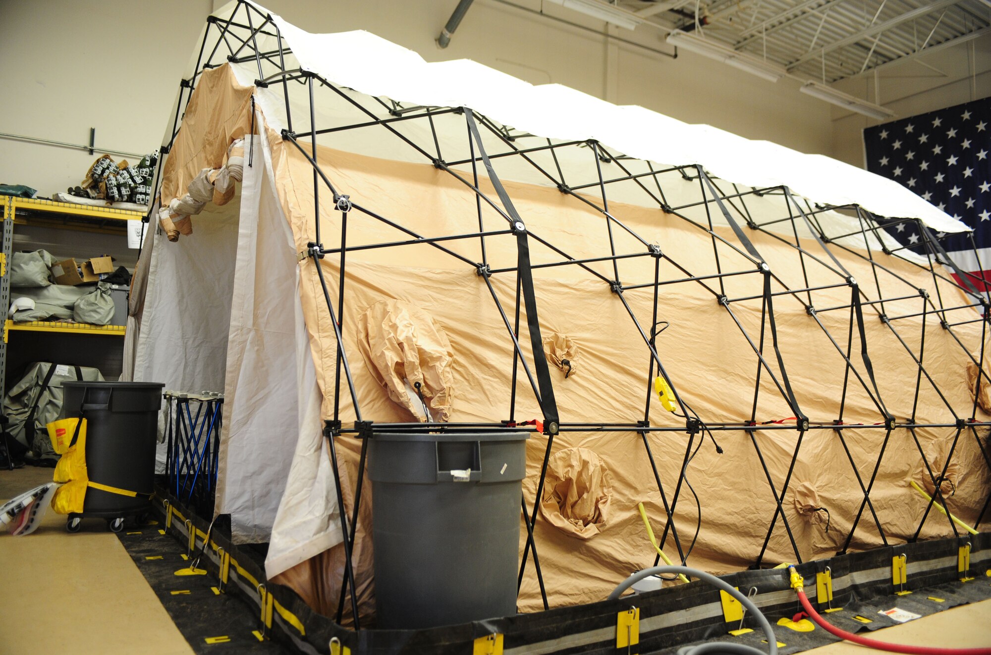 A decontamination tent sits in a warehouse as part of a decontamination seminar being held at Cannon Air Force Base, N.M., Feb.  21, 2013. The seminar consisted of class instruction followed by skill application. (U.S. Air Force photo/Airman 1st Class Ericka Engblom)