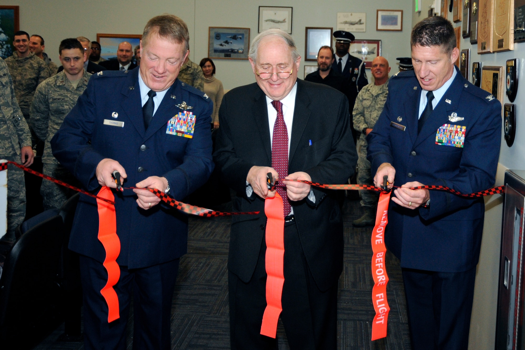 (from left to right) Colonel Michael T. Thomas, 127th Wing commander, Senator Carl Levin, and Colonel Douglas Champagne, 127th Operations Group commander, cut the ribbon to the entrance of the new Operations Group facility at a ceremony held on February 22 at Selfridge Air National Guard Base, Mich. The new $6.6 million building hosts the Operations Group command staff, the 107th Fighter Squadron and the 127th Operations Support Flight.   (photo by John S. Swanson)