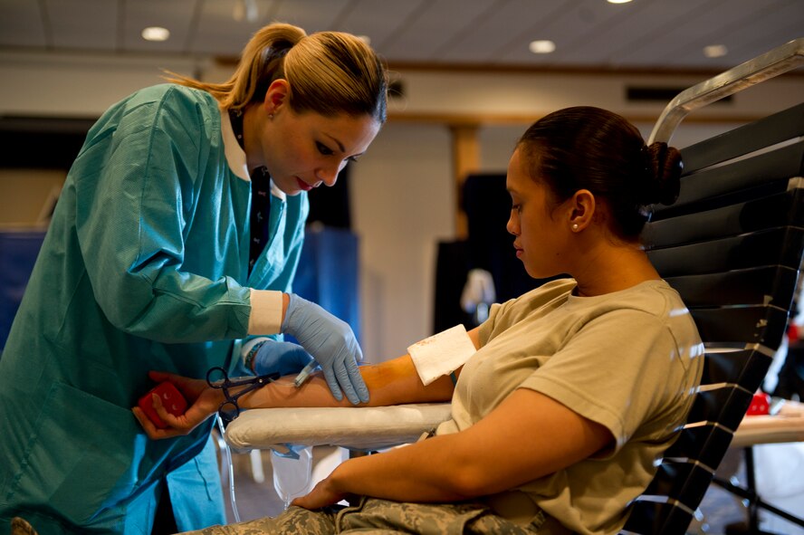Brenda Islas, William Beaumont Army Medical Center medical technician, prepares Senior Airman Yesenia Benjamin’s arm for a blood donation during an Armed Services Blood Program blood drive at Holloman Air Force Base, N.M., Feb. 20. Benjamin is a 49th Aerospace Medicine Squadron public health technician. Holloman AFB donated 32 units of blood during the drive. One donation can save three lives. (U.S. Air Force photo by Senior Airman Kasey Close/Released)