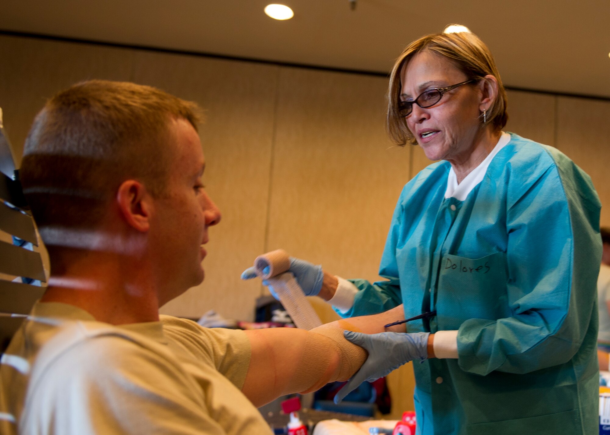 Dolores Meadina, William Beaumont Army Medical Center medical technician, wraps up Staff Sgt. Jeffrey Lawson’s arm after giving a donation during an Armed Services Blood Program blood drive at Holloman Air Force Base, N.M., Feb. 20. Lawson is a 49th Material Maintenance Squadron unit deployment manager (U.S. Air Force photo by Senior Airman Kasey Close/Released)