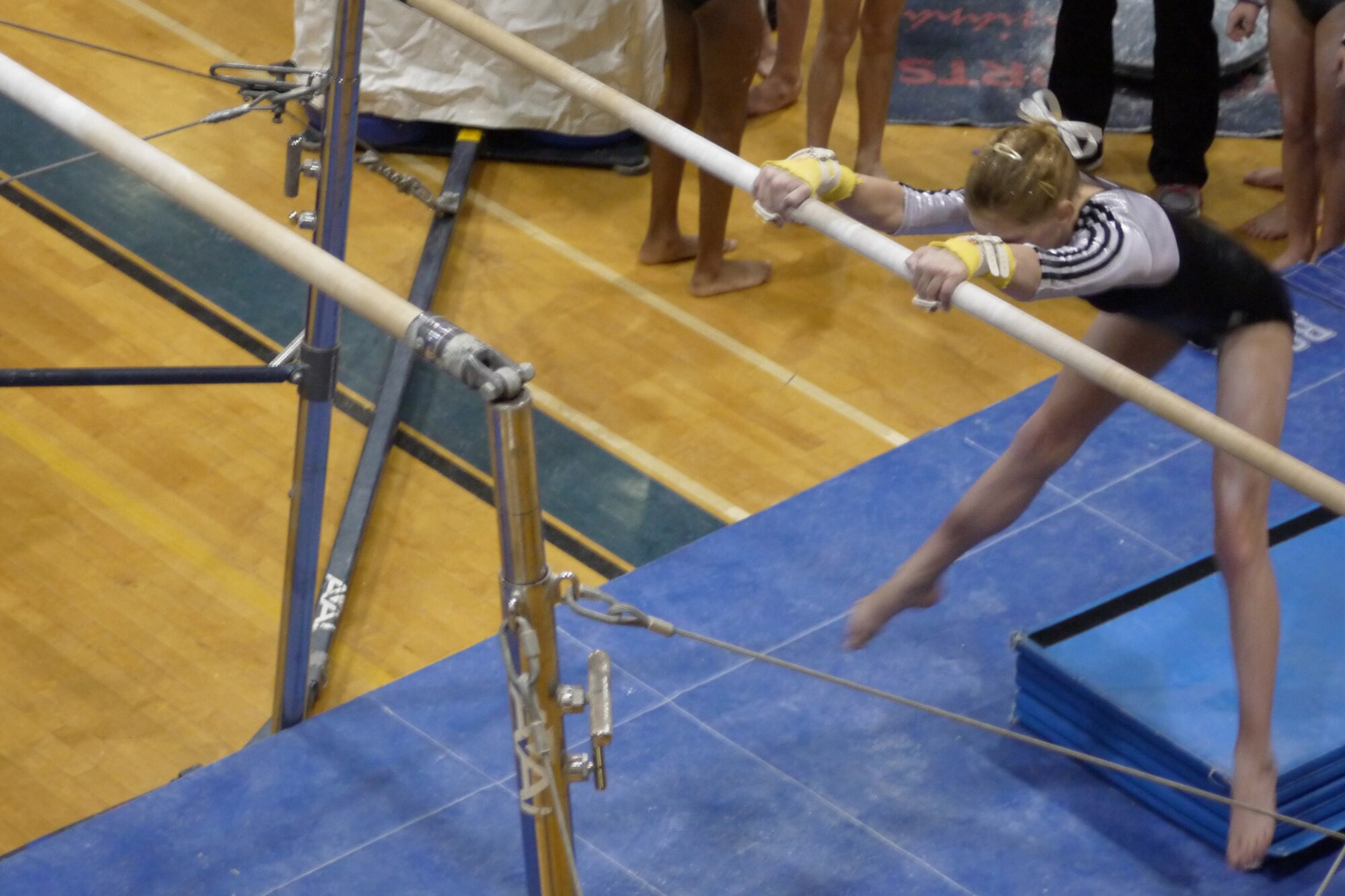 Renae Suberly, daughter of Maj. Michael Suberly, 8th Air Force Office of the Staff Judge Advocate, and Maj. Michelle Suberly, Air Force Global Strike Command Office of the Staff Judge Advocate, competes on the uneven bars during the Emerald Classic Feb 16-17 in Cabot, Ark. Suberly her team to a first-place finish in the competition.