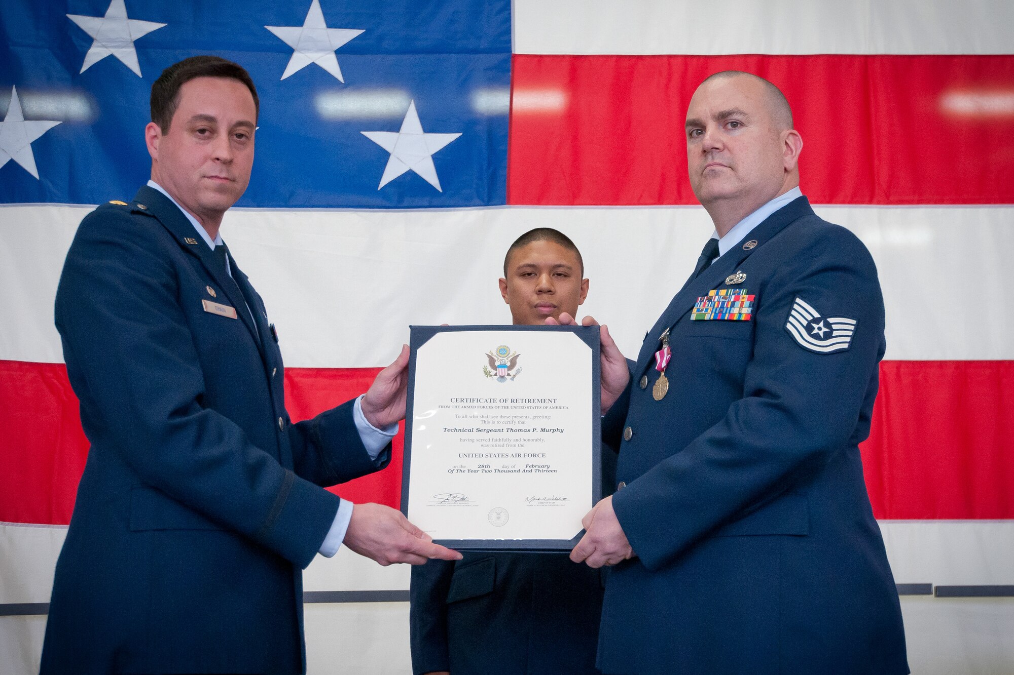 Maj. John Drain, 934th Maintenance Operations Flight commander, presents Tech. Sgt. Thomas Murphy with his certificate of retirement at the Minneapolis-St. Paul Air Reserve Station, Minn.  (U.S. Air Force photo/Paul Zadach)