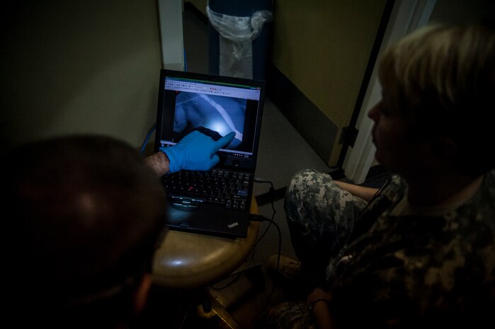 Major Brent Waldman, 628th Medical Group Dental Clinic general dentist, and Army Capt. Cynthia Fallness, Joint Base Charleston Veterinary Clinic officer in charge, review Shark’s X-Rays before a root canal and teeth cleaning Feb. 20, 2013, at JB Charleston – Air Base, S.C.  Shark is a Military Working Dog assigned to the 628th Security Forces Squadron and works on both the Air Base and Weapons Station at JB Charleston. (U.S. Air Force photo/ Senior Airman Dennis Sloan)