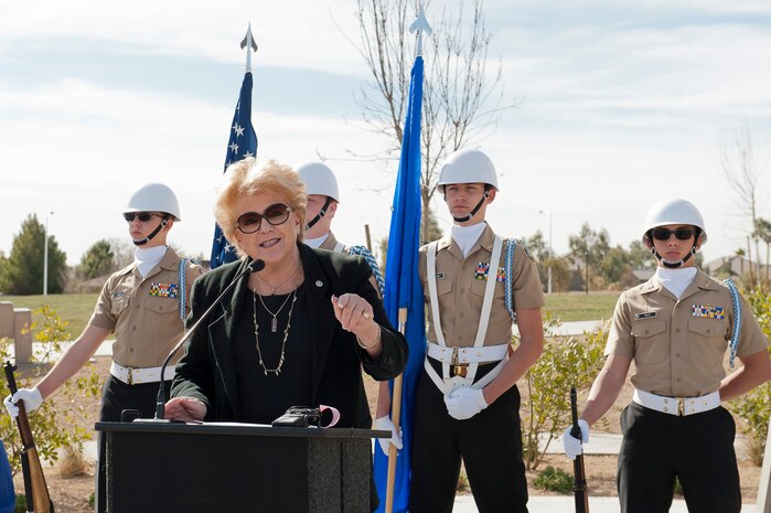 Las Vegas Mayor Carolyn G. Goodman provides opening remarks during the Raptor Play Park Grand Opening as the Centennial High School JROTC honor guard looks on Feb. 16, 2013. The F-22 Raptor is the centerpiece of the Thunderbird Family Sports Complex. (U.S. Air Force photo by Lawrence Crespo)