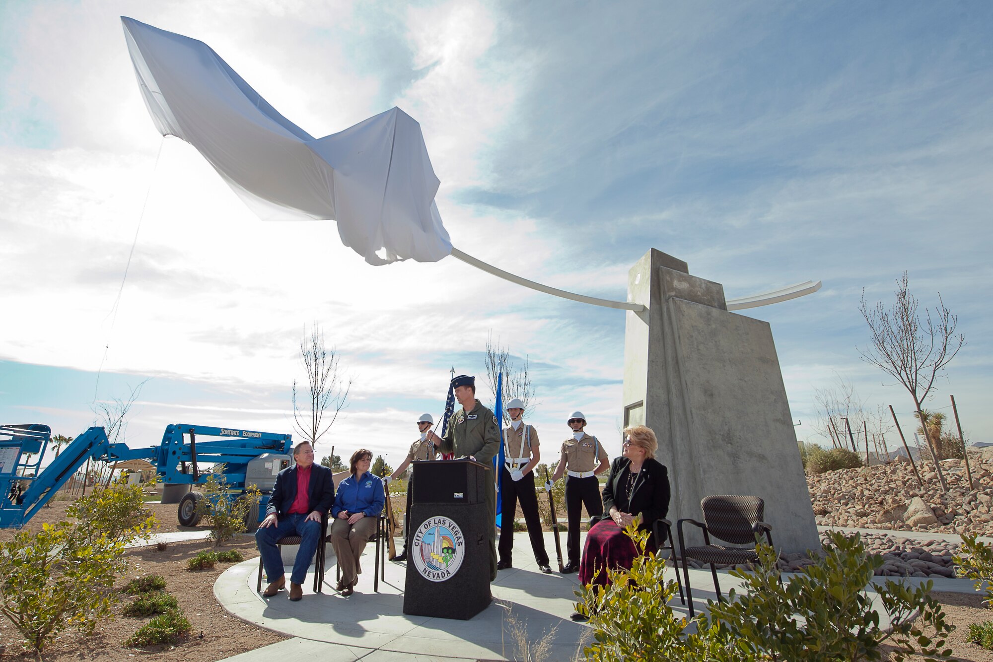 Brig. Gen. Charles Moore, 57th Wing commander, provides remarks during the Raptor Play Park Grand Opening as Las Vegas Councilman Steven Ross, City Manager Betsy Fretwell, Las Vegas Mayor Carolyn G. Goodman and the Centennial High School JROTC honor guard look on Feb. 16, 2013. The F-22 Raptor Stealth Fighter replica is the centerpiece of the Thunderbird Family Sports Complex located at 6105 N. Durango Drive, at the northwest corner of Tropical Parkway and Durango. (U.S. Air Force photo by Lawrence Crespo)