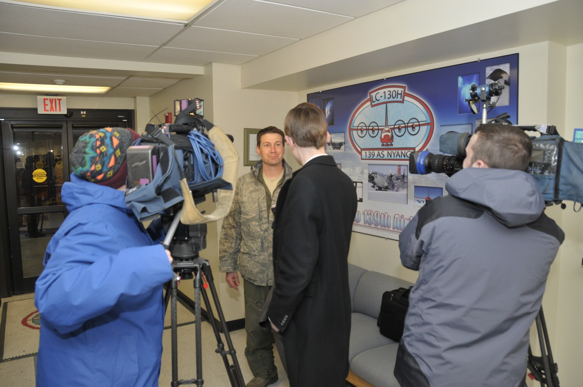 Maj Joshua Hicks, a pilot with the 109th Airlift Wing, New York Air National Guard, is interviewed by local media after flying an LC-130 aircraft from Antarctica back to New York.  The wing has just completed its 24th year supporting National Science Foundation operations throughout the continent of Antarctica.  (U.S. Air Force photo by MSgt. Willie Gizara/Released)