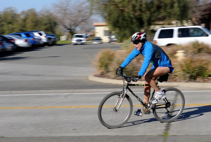 A competitor of the Recce Challenge Adventure Series Duathlon Race speeds towards the transition zone at Beale Air Force Base, Calif., Feb. 21, 2013. The transition zone is where participants transition from biking to running during the approximately 13 mile challenge. (U.S. Air Force photo by Staff Sgt. Robert M. Trujillo/Released)  