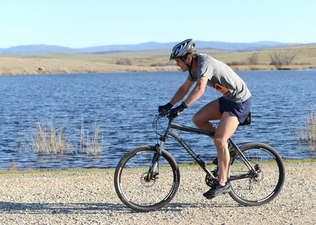 A competitor of the Recce Challenge Adventure Series Duathlon Race passes by Blackwelder Lake at Beale Air Force Base, Calif., Feb. 21, 2013. Competitors had to bike five miles, run three miles, then bike another five miles to complete the challenge. (U.S. Air Force photo by John Schwab/Released)