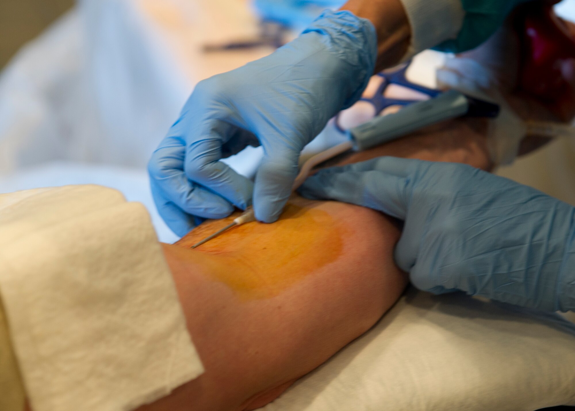 Dolores Meadina, William Beaumont Army Medical Center medical technician, inserts a needle into an Airman’s arm for a blood donation during an Armed Services Blood Program blood drive at Holloman Air Force Base, N.M., Feb. 20. The ASBP provides blood products for service members and their families.  (U.S. Air Force photo by Senior Airman Kasey Close/Released)