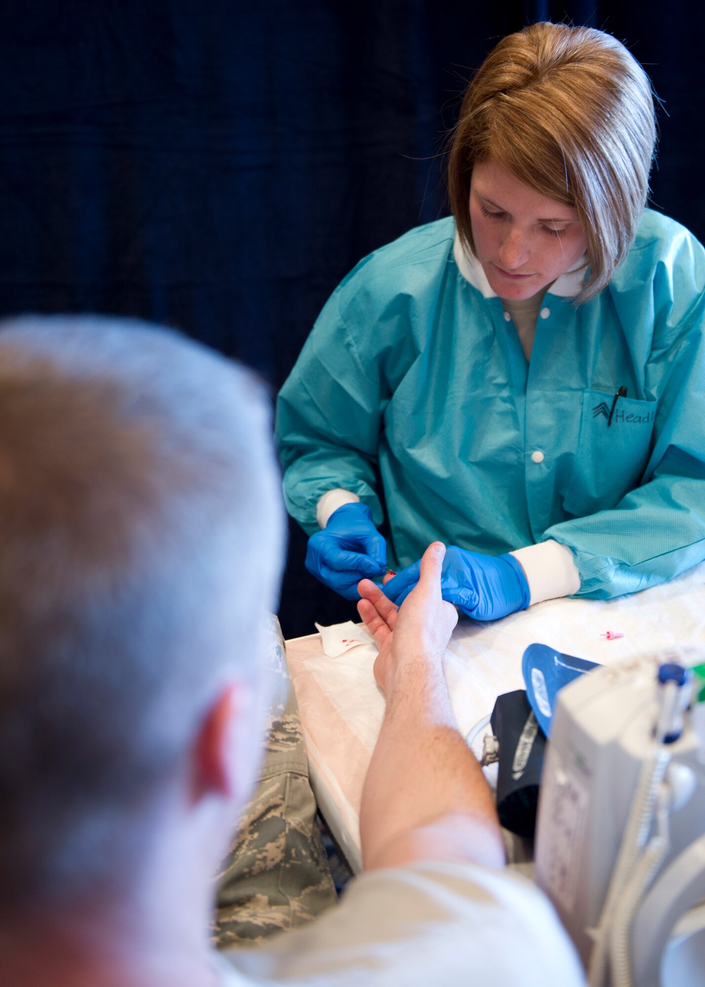 U.S. Army Sgt. Rene Headley, William Beaumont Army Medical Center mobile operations NCO-in-charge, samples an Airman’s blood for a hemoglobin test during an Armed Services Blood Program blood drive at Holloman Air Force Base, N.M., Feb. 20. Holloman AFB donated 32 units of blood during the drive. One donation can save three lives. (U.S. Air Force photo by Senior Airman Kasey Close/Released)