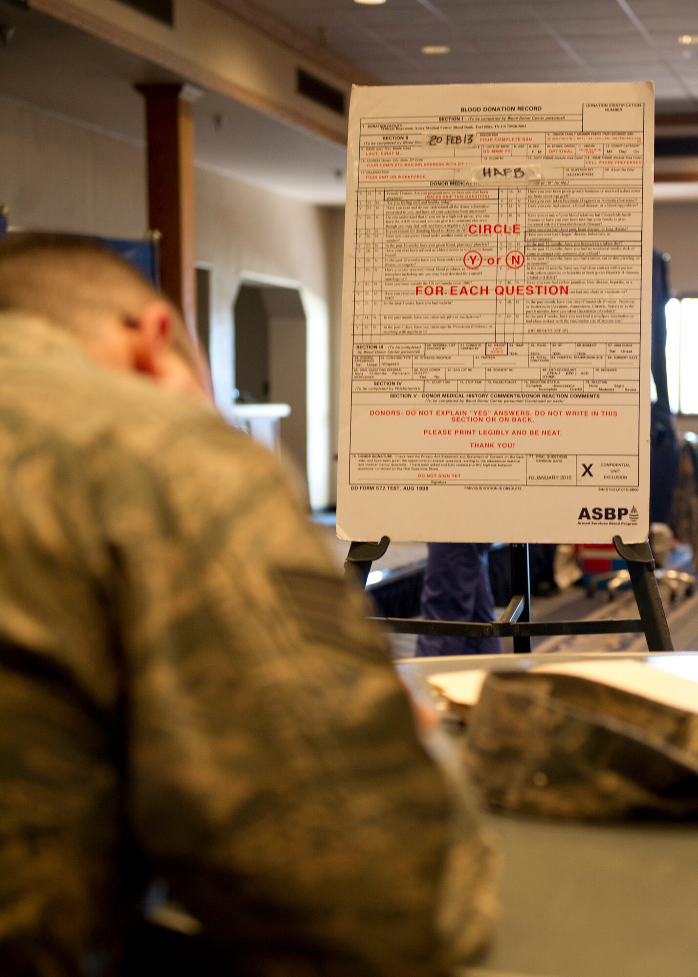 Staff Sgt. Scott Carter, 49th Civil Engineer Squadron firefighter, fills out a blood donation record during an Armed Services Blood Program blood drive at Holloman Air Force Base, N.M., Feb. 20. Holloman AFB donated 32 units of blood during the drive. One donation can save three lives. (U.S. Air Force photo by Senior Airman Kasey Close/Released)