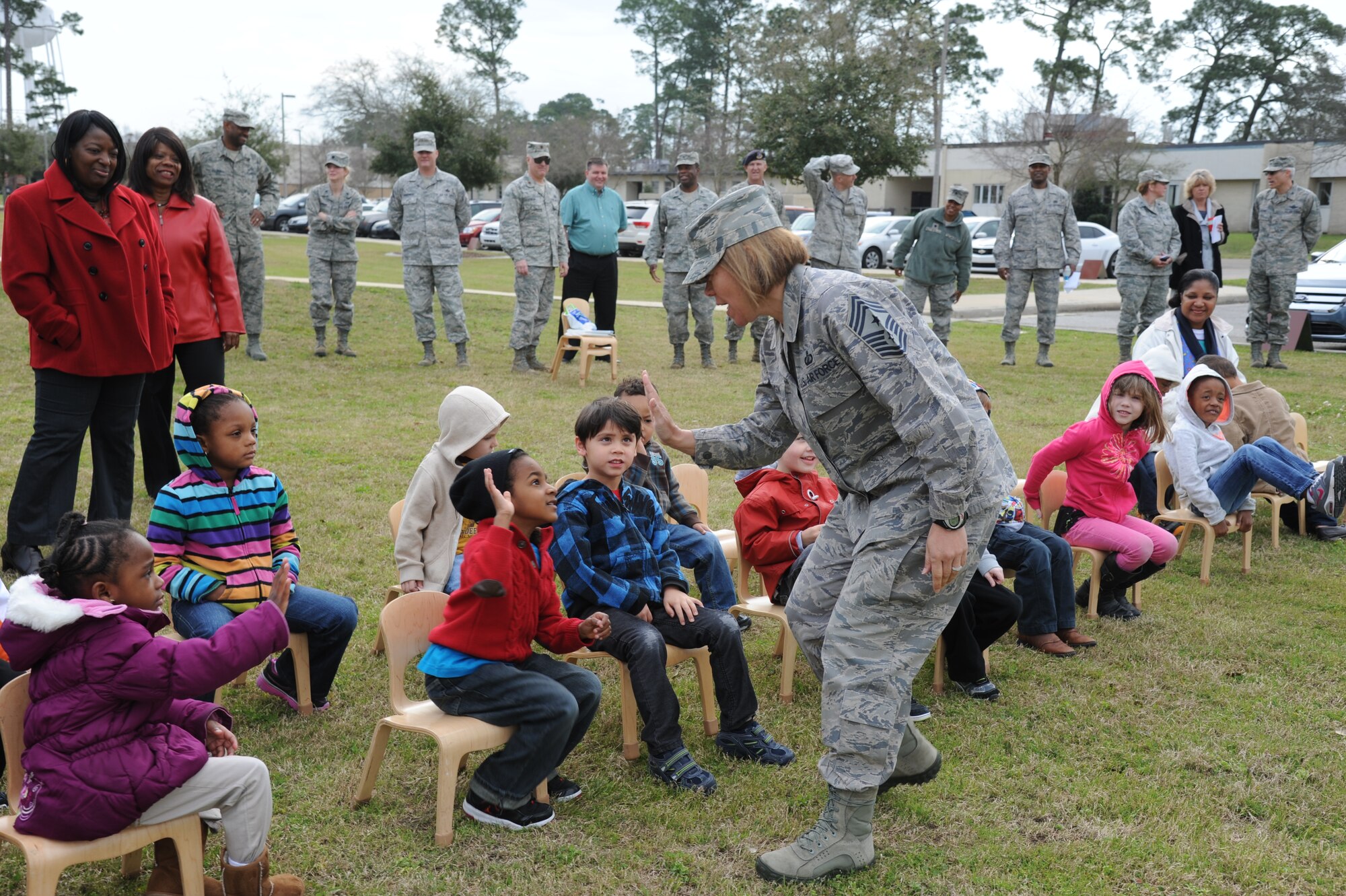 Chief Master Sgt. Angie Johnson, 81st Training Wing command chief, greets children from a 4-to-5-year-old class at the child development center Feb. 21, 2013, at Keesler Air Force Base, Miss., prior to a tree-planting ceremony in honor of Arbor Day.  The Tree City USA award was also presented to Keesler for the 20th consecutive year for its tree management program.  (U.S. Air Force photo by Kemberly Groue)