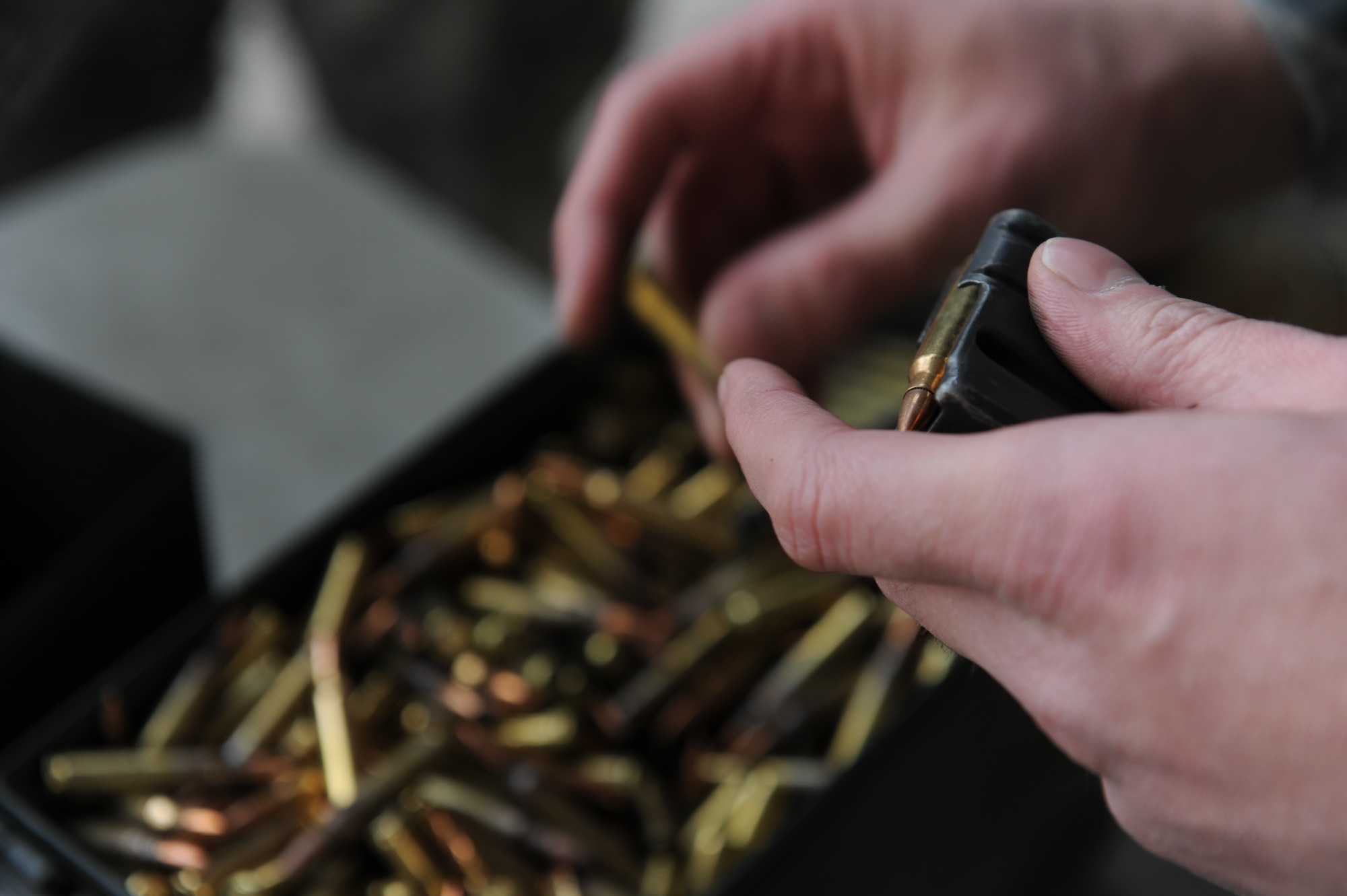 Ammunition is loaded into an M-4 magazine prior to a live-fire exercise during Threat Management Group’s Advanced Weapons and Tactics Training in Charleston, S.C. The two-week training gives students the opportunity to practice marksmanship fundamentals, by shooting more than 2,000 rounds at targets. (U.S. Air Force photo by Airman 1st Class Alexandra Minor)