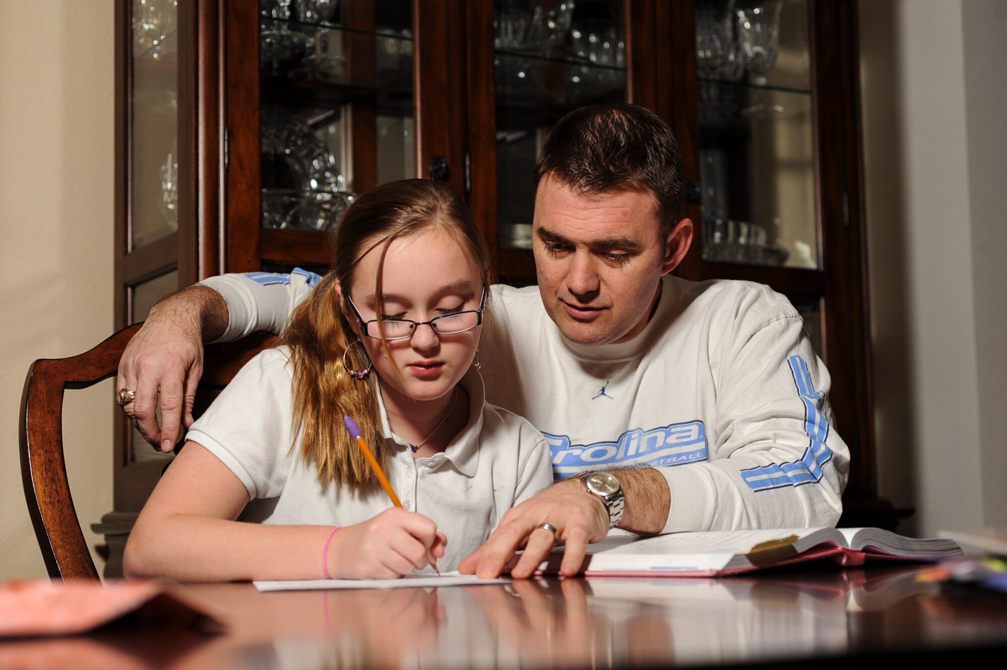 Col. Tracey Watkins, 19th Mission Support Group commander, helps his daughter with math homework Feb 20, 2013, at Little Rock Air Force Base, Ark. Watkins said his five kids are his single greatest accomplishment and that spending time with them is his first priority off-duty. (U.S. Air Force photo by Airman 1st Class Cliffton Dolezal)