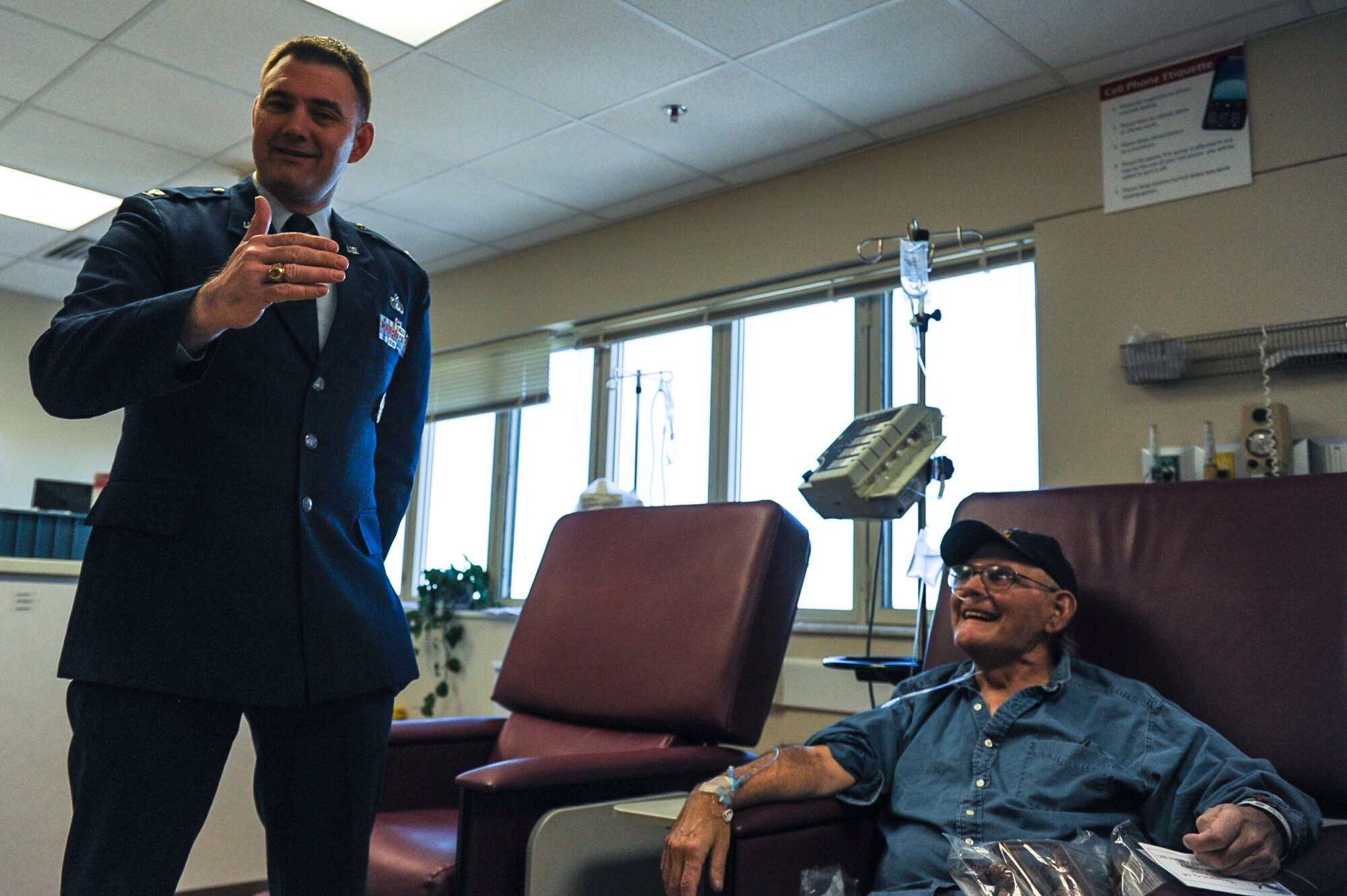 Col. Tracey Watkins, 19th Mission Support Group commander, talks with a veteran during the salute to veterans program Feb. 14, 2013, at the John L. McClellan Memorial Veterans Hospital in Little Rock, Ark. The national salute to veterans program is open to all and a great way to give thanks to those who have given so much. (U.S. Air Force photo by Airman 1st Class Cliffton Dolezal)
