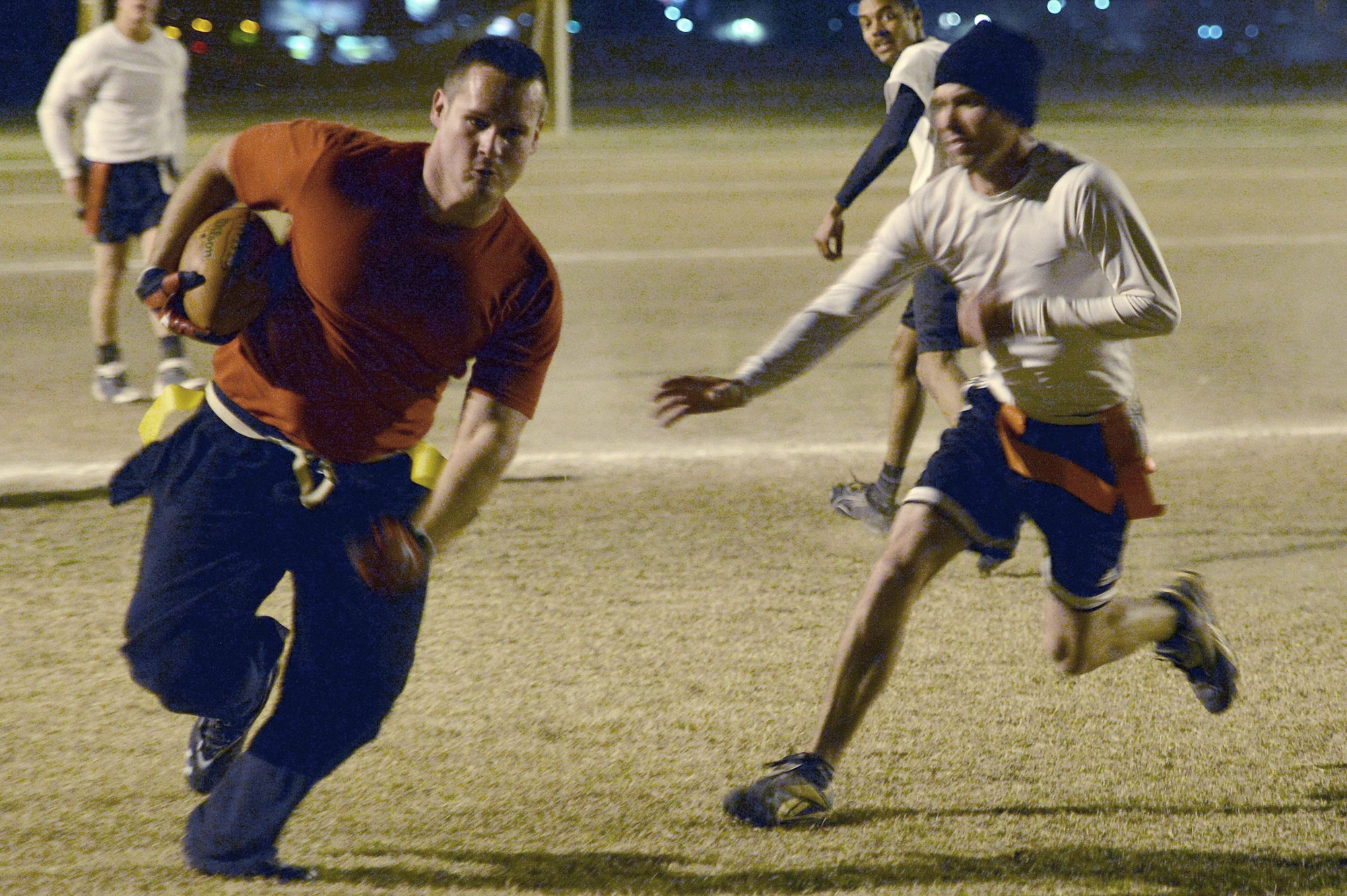 Derek Ezell, 56th Maintenance Operations Squadron, avoids a 56th Communications Squadron defender Feb. 13 during the flag football championship game at Luke Air Force Base. 56th MOS defeated 56th CS 40-13. (U.S. Air Force photo/Airman 1st Class Devante Williams