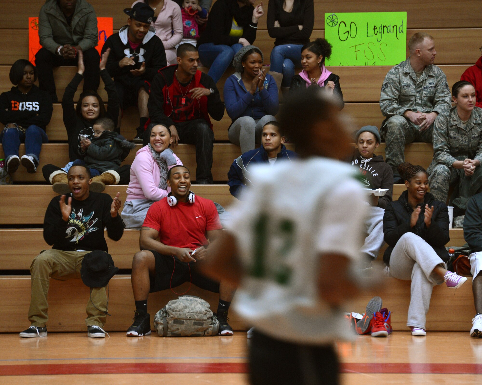 SPANGDAHLEM AIR BASE, Germany – Fans cheer as players from the 52nd Force Support Squadron and 52nd Logistics Readiness Squadron compete during the intramural basketball championship game Feb. 21, 2013. The 52nd FSS defeated the 52nd LRS 46-41 to claim their second consecutive intramural sports title. (U.S. Air Force photo by Staff Sgt. Nathanael Callon/Released)