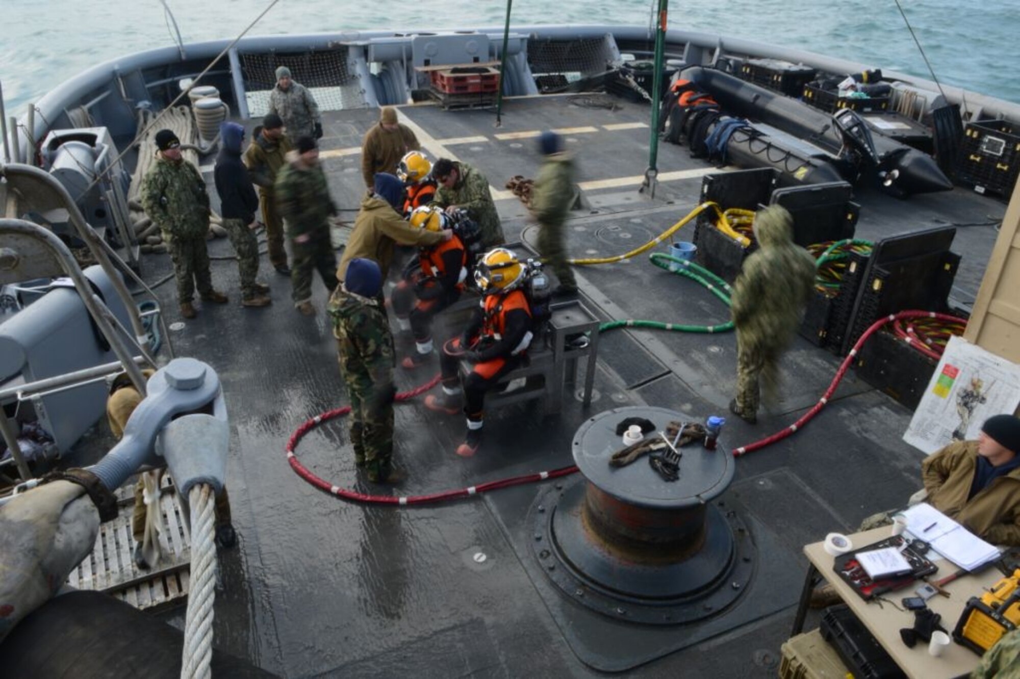 U.S. Navy divers from the Mobile Diving Salvage Unit 2, Company 4, prepare for a surface supply dive in the Adriatic Sea aboard the salvage vessel USNS Grapple (T-ARS 53), Feb. 14, 2013.  Navy divers are performing deep sea salvage operations from Grapple to help find wreckage from an F-16 Fighting Falcon which crashed in the Adriatic Sea, Jan. 28.  (U.S. Air Force photo by Staff Sgt. Evelyn Chavez/Released)