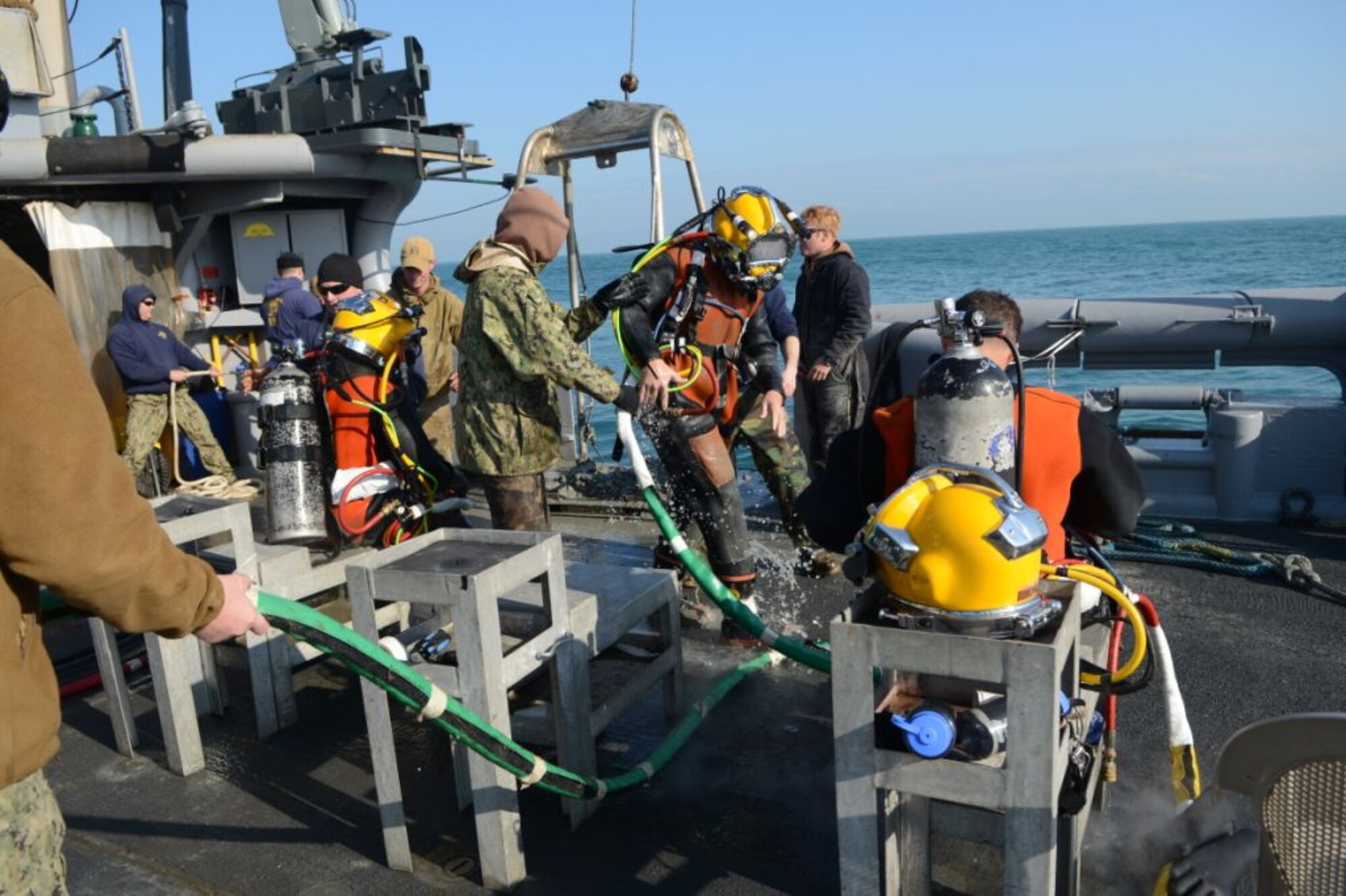 U.S. Navy divers from Mobile Diving Salvage Unit 2, Company 4, assist in a surface supply dive into the Adriatic Sea aboard the salvage vessel USNS Grapple (T-ARS 53), Feb. 14, 2013. Navy divers are performing deep sea salvage operations from Grapple to help find wreckage from an F-16 Fighting Falcon which crashed in the Adriatic Sea, Jan. 28.  (U.S. Air Force photo by Staff Sgt. Evelyn Chavez/Released)