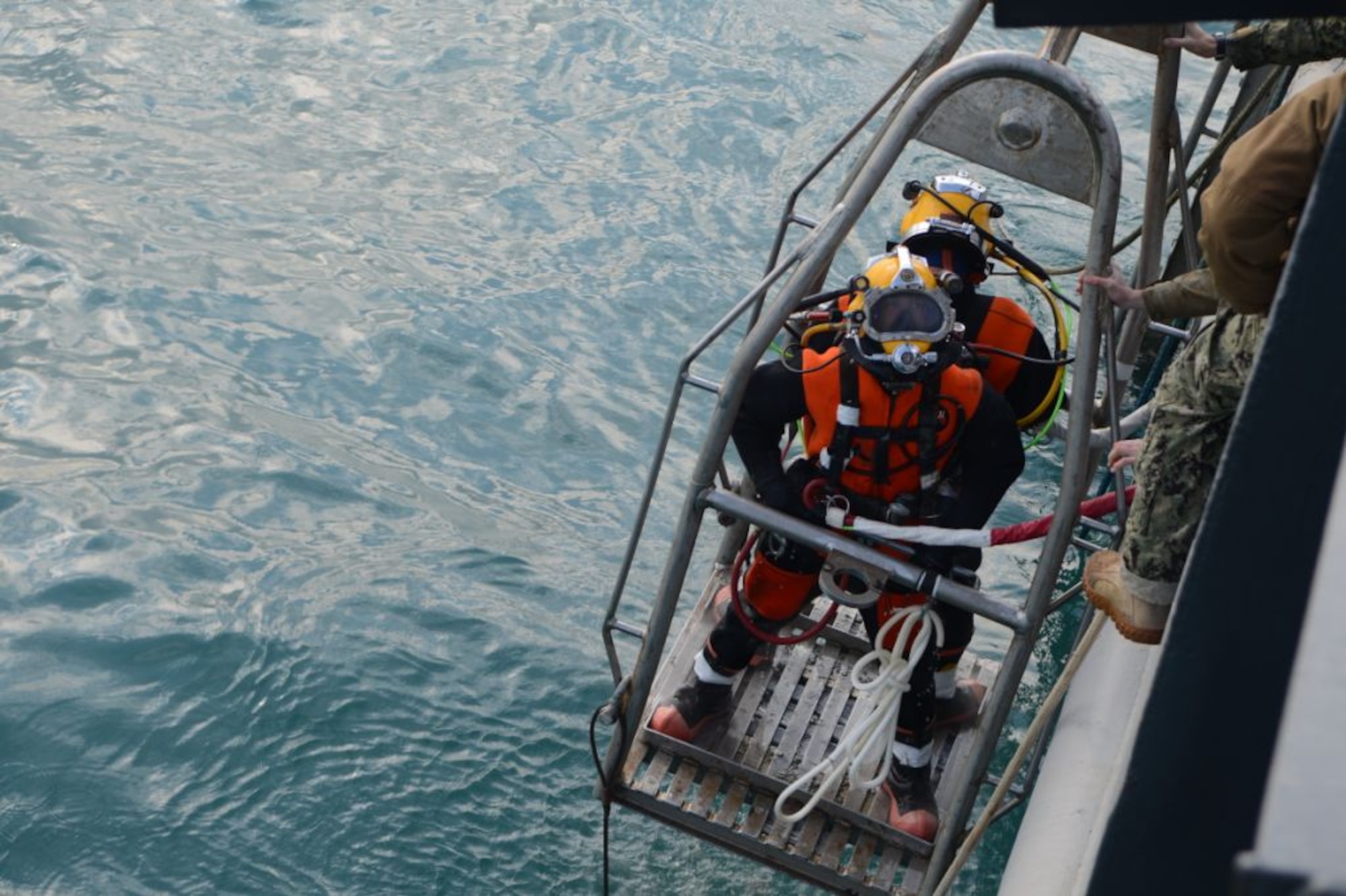 Navy divers from Mobile Diving Salvage Unit 2, Company 4, prepare to dive from the salvage vessel USNS Grapple (T-ARS 53), Feb 14, 2013. Navy divers are performing deep sea salvage operations from Grapple to help find wreckage from an F-16 Fighting Falcon which crashed in the Adriatic Sea, Jan. 28.  (U.S. Air Force photo by Staff Sgt. Evelyn Chavez/Released)