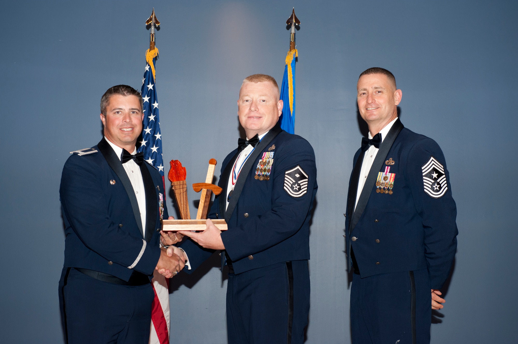 Master Sgt. Toby Spraberry, 53rd Weapons Evaluation Group, receives the 2012 Team Tyndall Annual Award for First Sergeant of the Year Feb. 20 from Col. David Graff, 325th Fighter Wing commander and Chief Master Sgt. Ray DeVite, 325th FW command chief. (U.S. Air Force photo by Lisa Norman)
