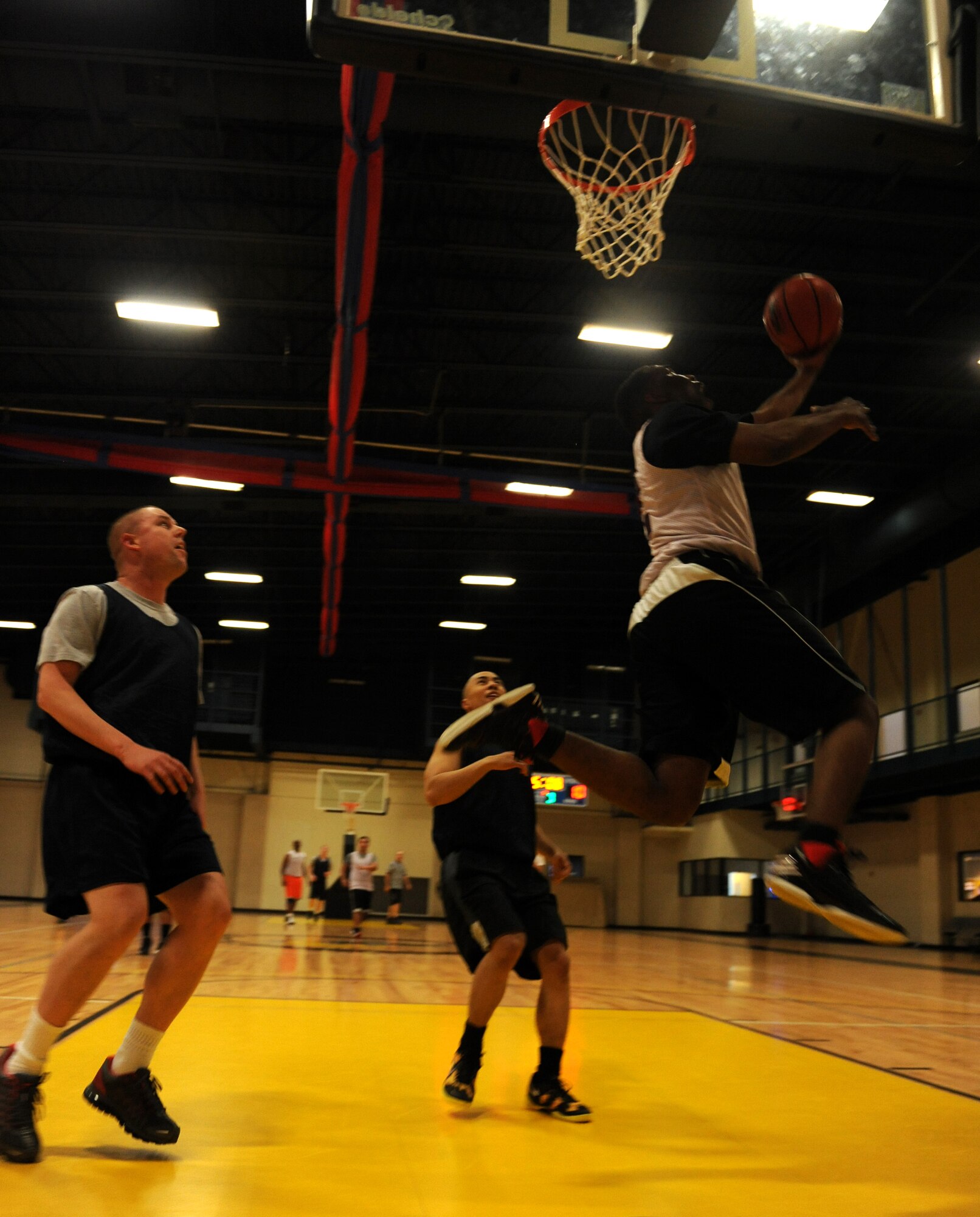 Robert Stevens, a 314th Operations Group basketball player, attempts a layup during an intramural game against the 19th Communications Squadron Feb. 19, 2013, at Little Rock Air Force Base, Ark. The game was close, with the 314th OG wining 40-37. (U.S. Air Force photo by Airman Scott Poe)