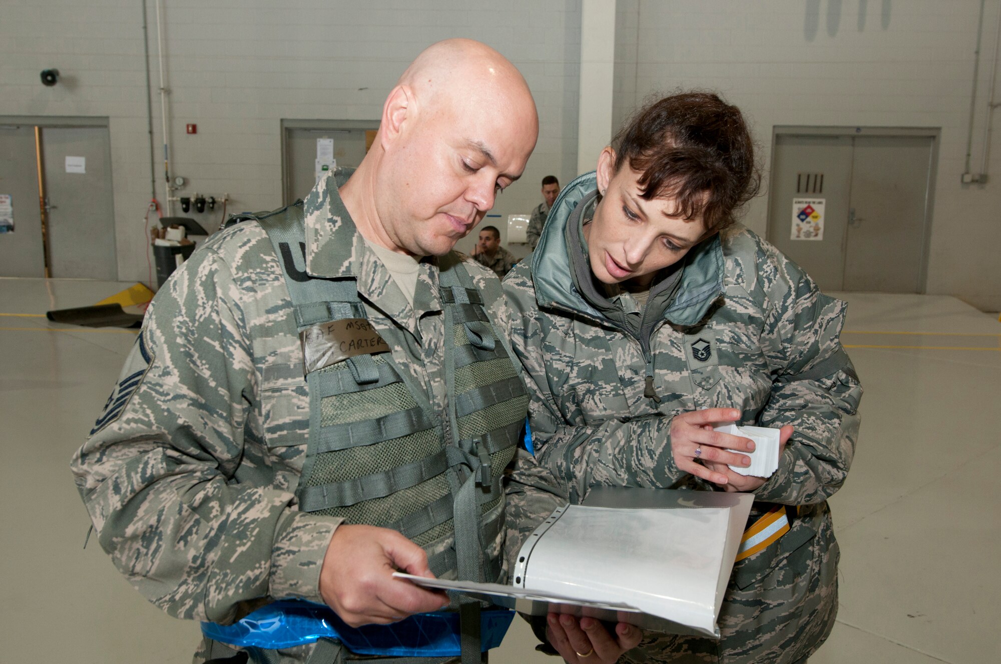 Master Sgt. Harry J. Carter of the 130th Airlift Wing and Master Sgt. Denise M. Hondel of the 153rd Airlift Wing, members of Personnel Flight, schedule the details of arriving airmen during an Operational Readiness Exercise at the Mississippi Air National Guard's Combat Readiness Training Center Gulfport in Gulfport, Miss. The 134th AEW is comprised of four units: the 153rd Airlift Wing, the 130th Airlift Wing, the 375th Air Mobility Wing and the 11th Wing. The exercise assesses the abilities of the individual units to deploy forces, quickly respond and recover assets during a weeklong exercise conducted and graded by an Exercise Evaluation Team. (U.S. Air Force Photo by Tech. Sgt. Bryan G. Stevens/Released)