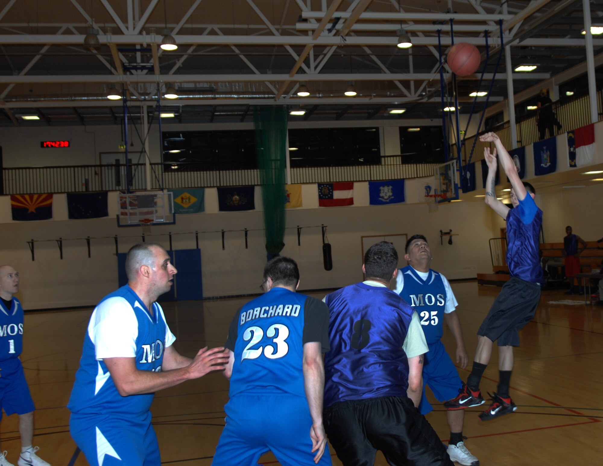 Airman 1st Class James Brooks, 100th Logistics Readiness Squadron fuels distribution operator from Fayetteville, Ark., shoots the ball over members of both teams during an intramural basketball game between the 100th LRS and the 100th Maintenance Operations Squadron Feb. 20, 2013, at the Hardstand Fitness Center on RAF Mildenhall, England. The 100th LRS was victorious over the 100th MOS 45-35. (U.S. Air Force photo by Airman 1st Class Dillon Johnston/Released)