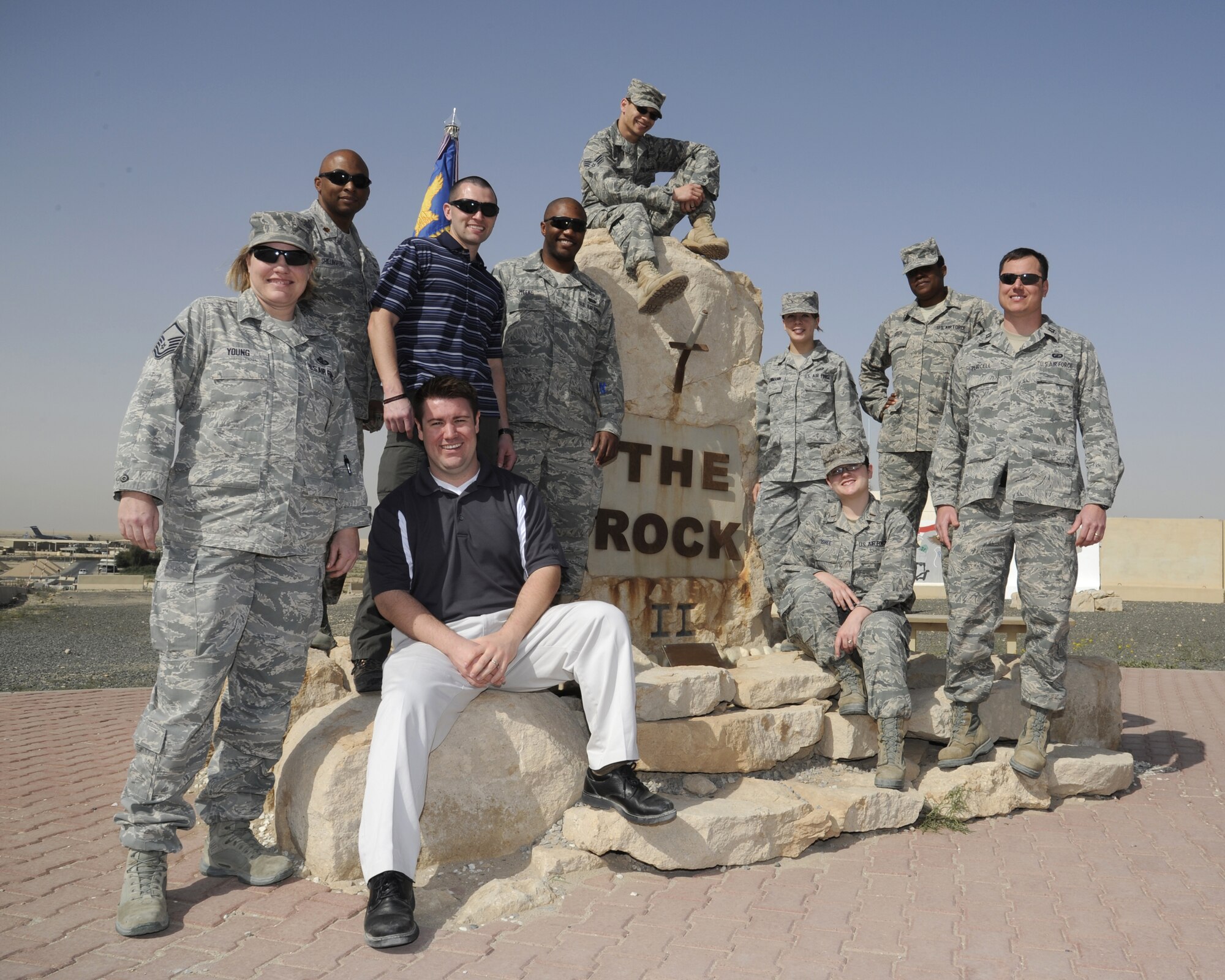 The 386th Expeditionary Contracting Squadron supports their “Rock Solid Warrior” award winners, Tech. Sgt. Jerry Meeks and Senior Airman Anthony Love (center, respectively) Feb. 19, 2013 at an undisclosed deployed location in Southwest Asia.  (U.S. Air Force photo by Staff Sgt. Austin Knox)