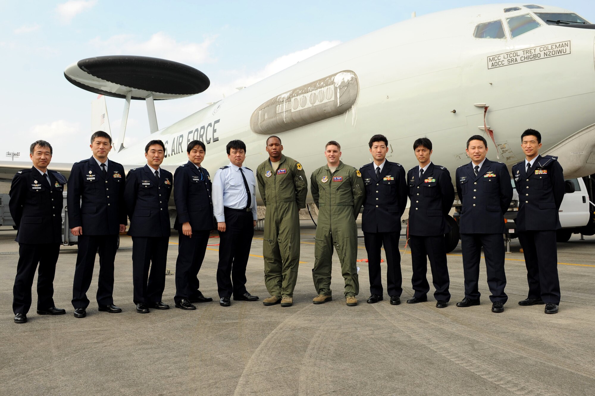 Japan Air Self-Defense Force personnel participate in a group photo with the 961st Airborne Air Control Squadron personnel during a tour on Kadena Air Base, Japan, Feb. 20, 2013.  The JASDF personnel visited the 909th Air Refueling Squadron, the 33rd Rescue Squadron and the 961st AACS during their tour of Kadena Air Base. (U.S. Air Force photo/Airman 1st Class Hailey R. Davis)