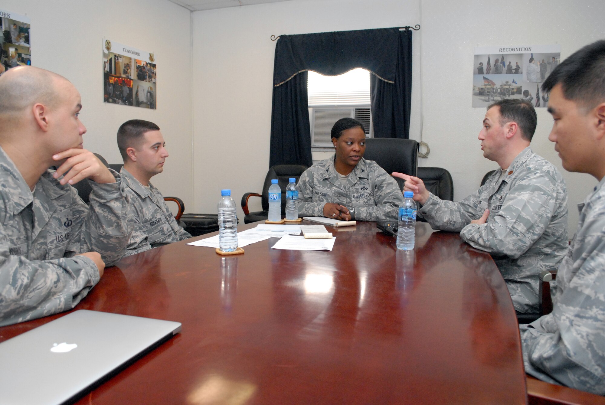 SOUTHWEST ASIA -- 379th Expeditionary Support Group Commander Col. Stephanie Wilson, center, is briefed on the base acquisition process by, from left, 379th Expeditionary Contracting Squadron members Master Sgt. Daryl Brooks, ECONS superintendent, Senior Airman Adam Gilreath, contracting officer, Maj. Richard Hulun, commander, and 1st Lt. David Won, base support flight commander, Feb. 15. The 379th ECONS serves the 379th Air Expeditionary Wing in Southwest Asia by managing the purchasing and acquisition for materiel needed to keep the mission properly supplied. (U.S. Air Force photo/Master Sgt. Christian Michael)