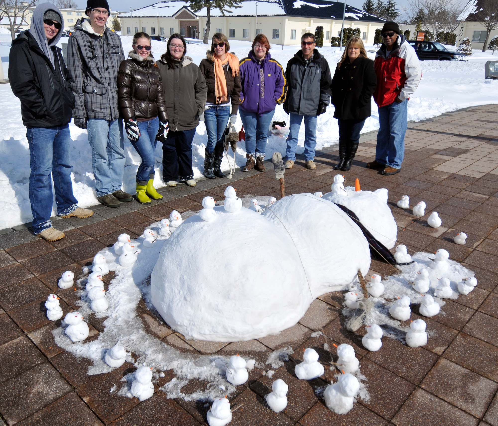 Members of the Misawa Theater Group pose with their sculpture after winning the first place prize of a $250 gift card during the Second Annual Snowman Build Competition Feb. 16, 2013, at Misawa Air Base, Japan. Their rendition of a scene from Gulliver’s Travels, a novel authored by Johnathan Swift, put them ahead of the competition. The sculptures will remain in Risner Circle until they melt away. (U.S. Air Force photo by Tech. Sgt. Phillip Butterfield)