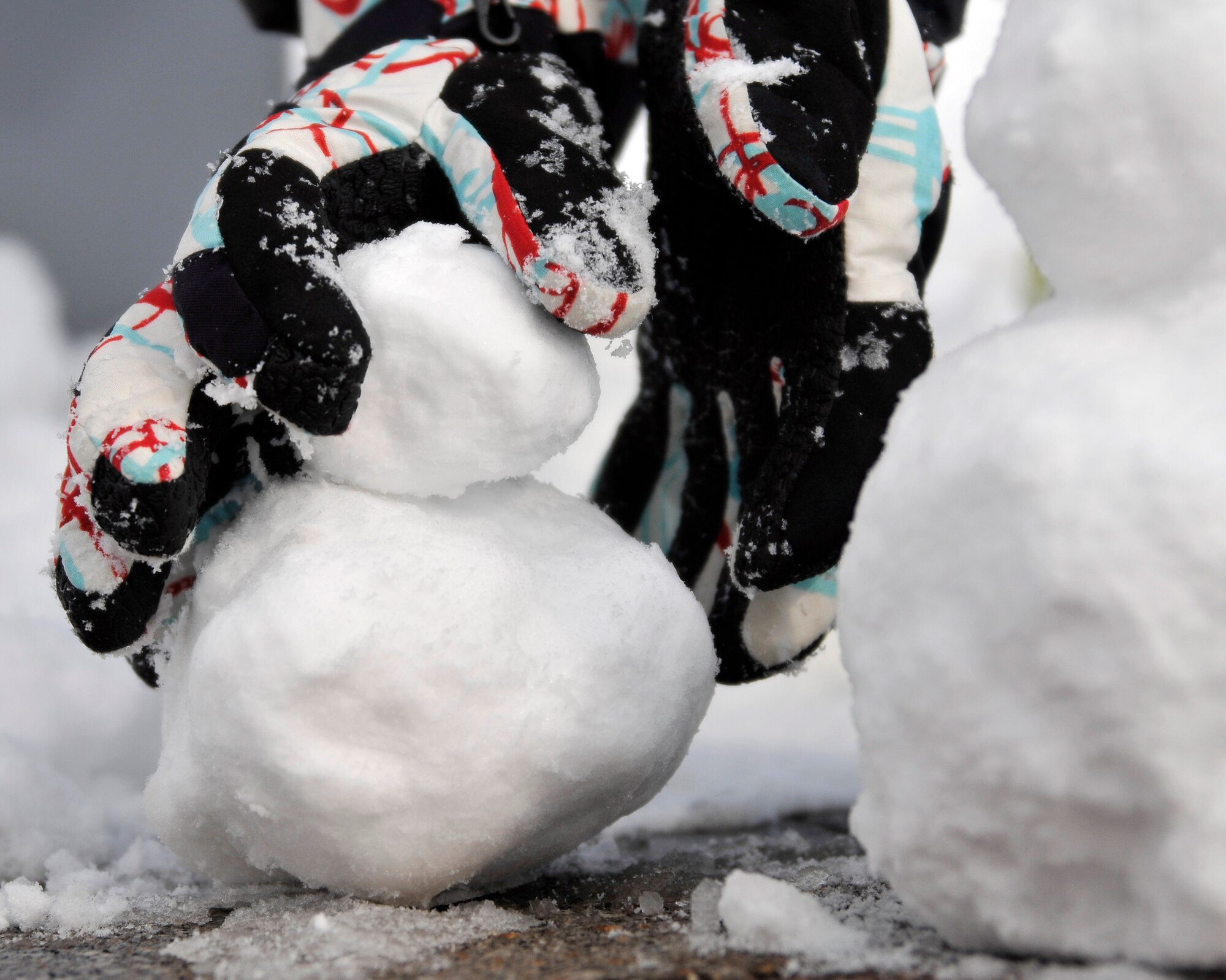 Asper Holmes, a member of the Misawa Theater Group, places the head on a tiny snowman during the Second Annual Snowman Build Competition Feb. 16, 2013 in Risner Circle at Misawa Air Base, Japan. The theater group’s creation was inspired by the Johnathan Swift novel, Gulliver’s Travels, and it won the first place prize of a $250 gift card. (U.S. Air Force photo by Tech. Sgt. Phillip Butterfield)