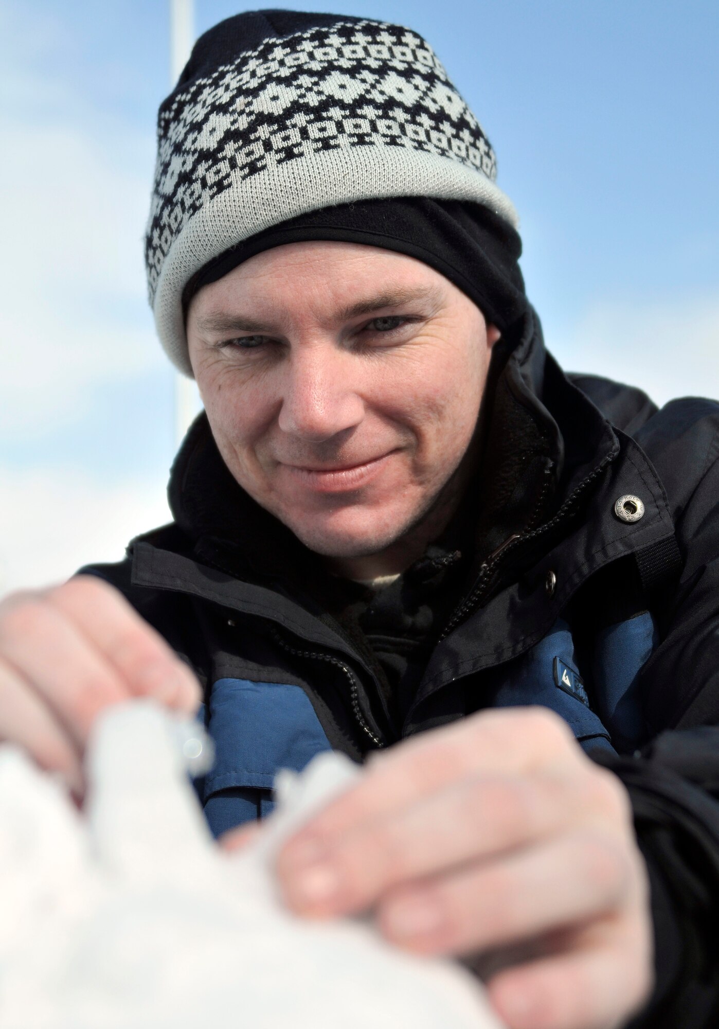 U.S. Air Force Tech. Sgt. Jason McQuarrie, 35th Maintenance Operations Squadron chief of training management, uses a pick to fashion a mohawk on his teams sculpture during the Second Annual Snowman Build Competition in Risner Circle at Misawa Air Base, Japan Feb. 16, 2013. McQuarrie was a member of the First Sergeants Team, whose entry was a surfer being chased by a shark. (U.S. Air Force photo by Tech. Sgt. Phillip Butterfield)